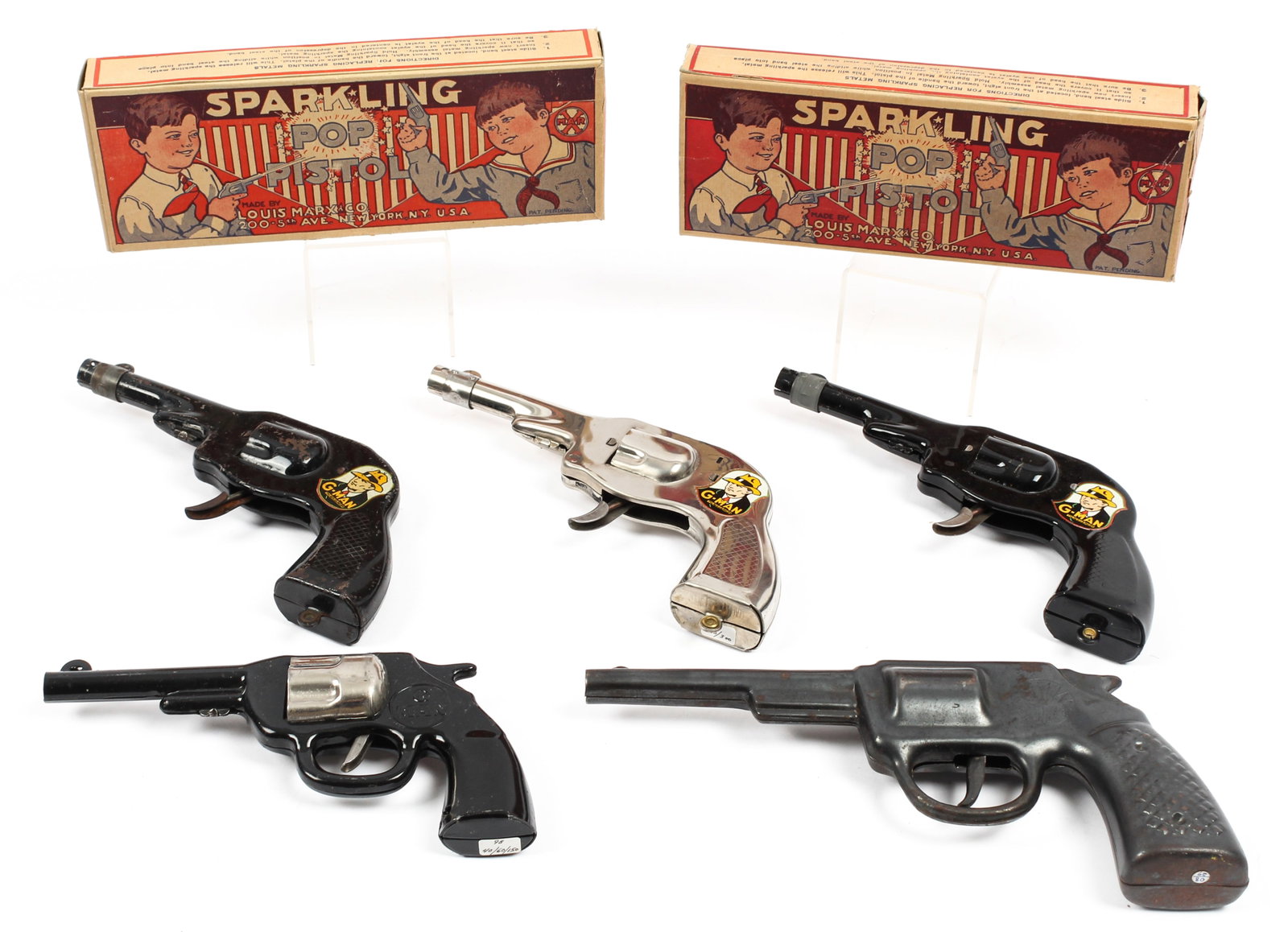 Five G Man Toy Guns Incl. Marx Sparkling Pop Pistol W/ Oiginal Box: Description: A group of five vintage G Man toy guns including three Marx sparkling pop pistols (two with the original boxes), and two other G Man revolver form pistols. Type: Toy gun Materials: Metal 
