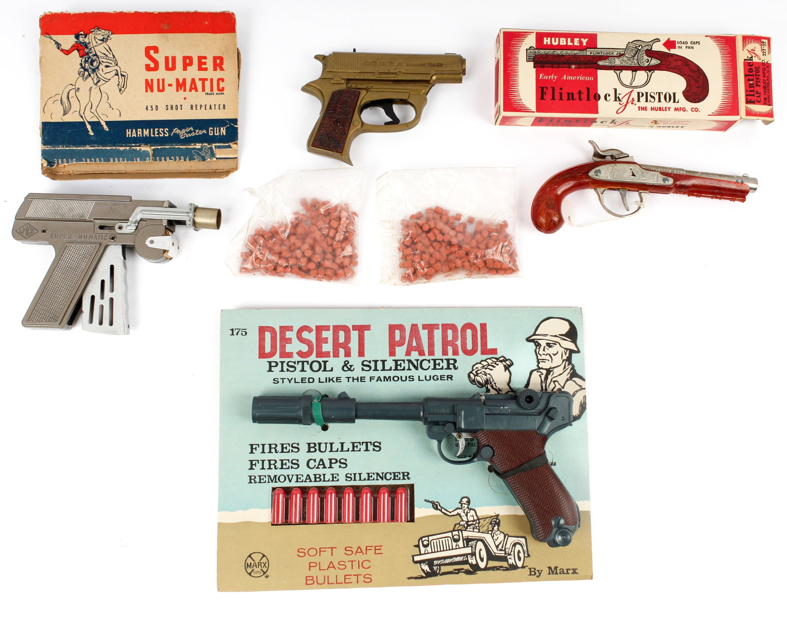 Four Vintage Toy Guns Incl. Marx Desert Patrol Pistol, Hubley Flintlock Pistol, LMCO, Cobra: Description: A collection of 4 toy guns to include: a Marx 'Desert Patrol' pistol with silencer on its original board, a Hubley Flintlock Jr. cap gun pistol with its original box, an LMCO Super Nu-Mat
