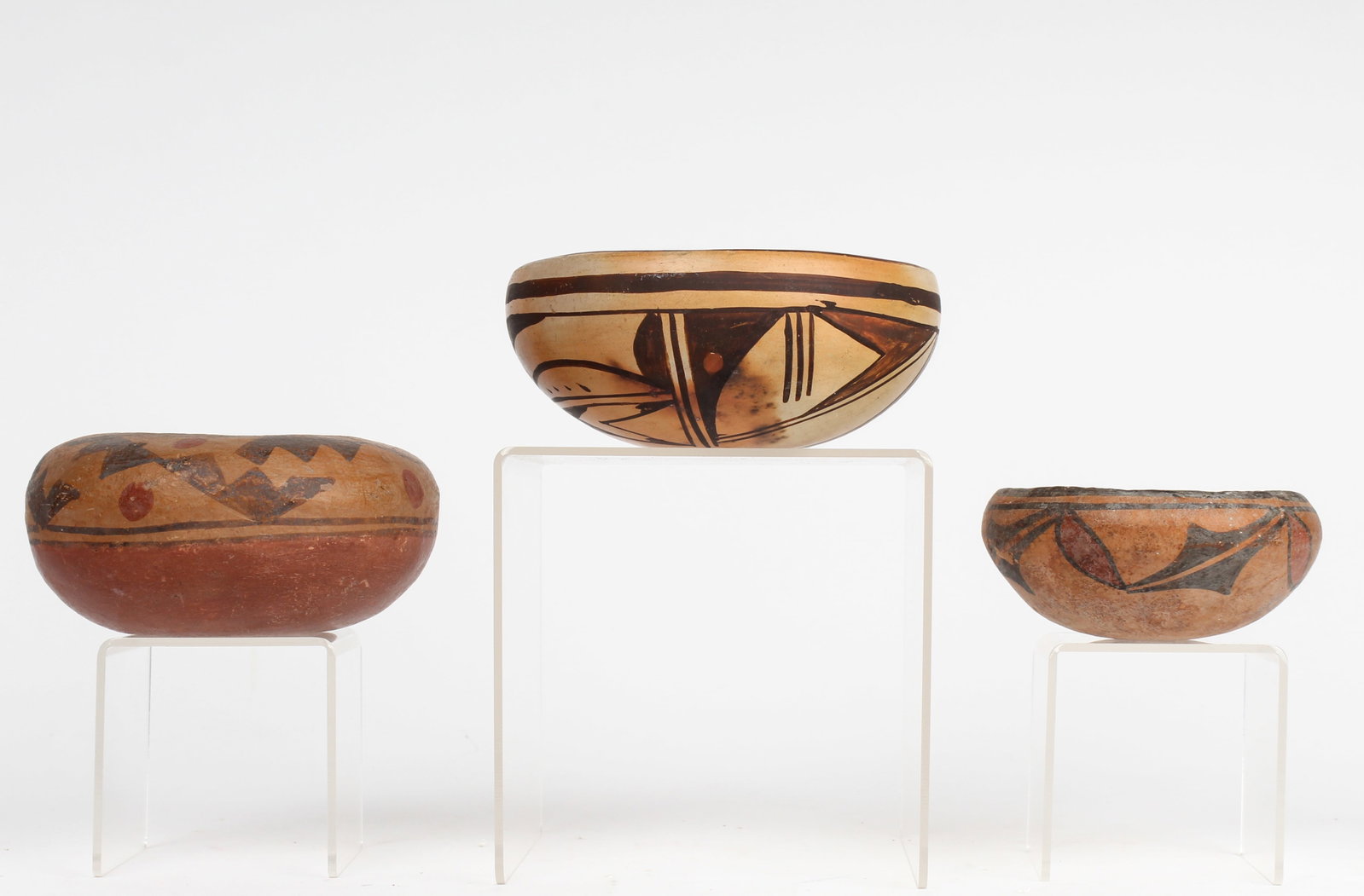 1930s Native American Hopi Pueblo Pottery Bowls: Description: Three bowls with varied polychromed geometric decoration. Materials: Pottery Markings & Inscriptions: Unmarked Date: 1930s Maker: Native American, Hopi Dimensions: Largest: 2.25" x 5.25".