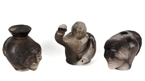 John Kurok, Ceramic Inuit Art Pottery Face Vessels, Sculpture: Description: Two carved and sculpted face vessels, each signed and dated 2003, one with a polar bear, both of Rankin Inlet, Nunavut origin, together with a pottery figure of an Inuit man, attributed t