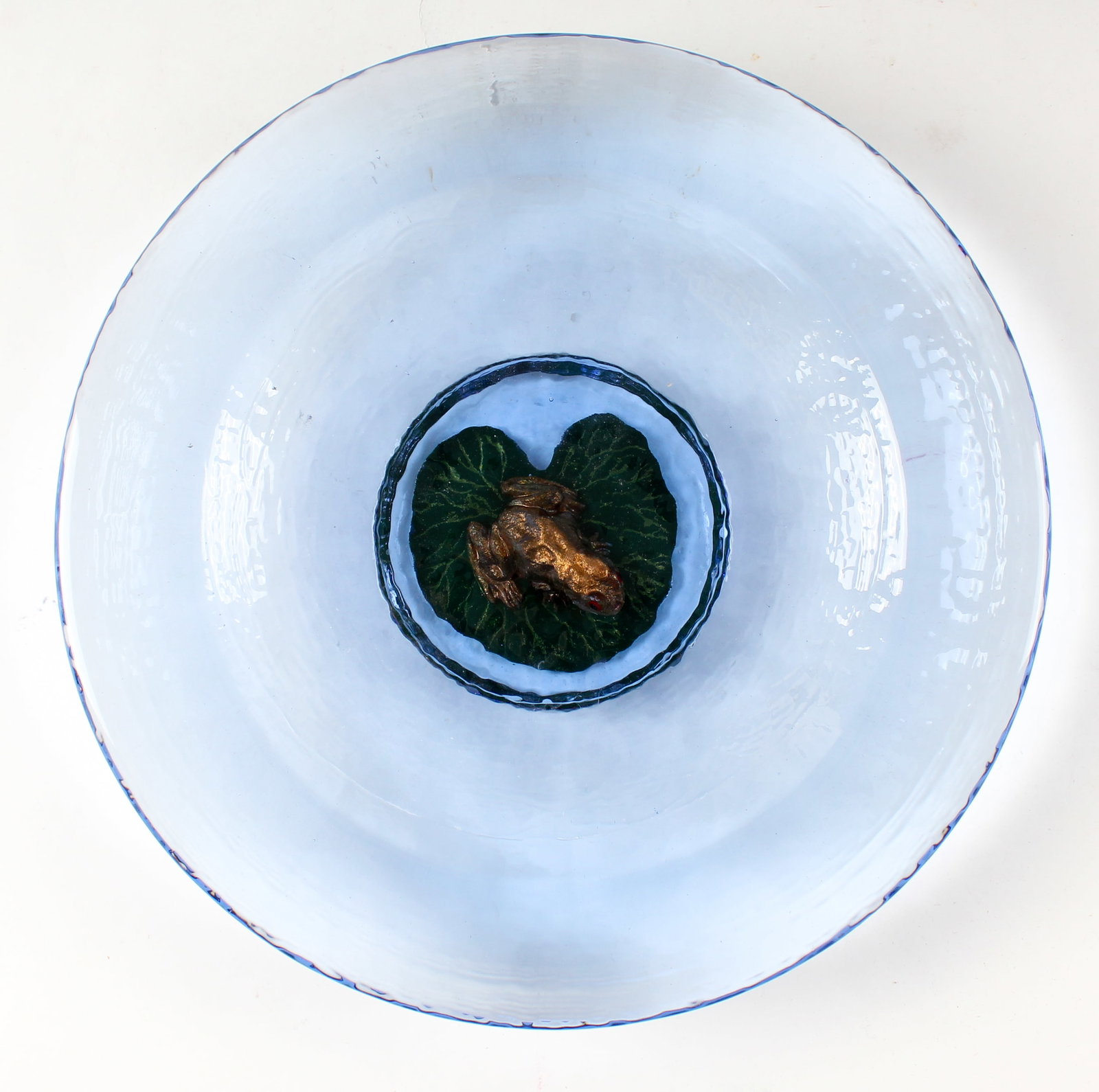 George Bucquet (American, B. 1954) Art Glass Frog & Lily Pad Bowl: Description: A cast art glass bowl in blue with a frog and lily pad in relief at the base. Markings & Inscriptions: Signed and dated Date:1996 Maker: George Bucquet (American, B. 1954) Dimensions: 12"