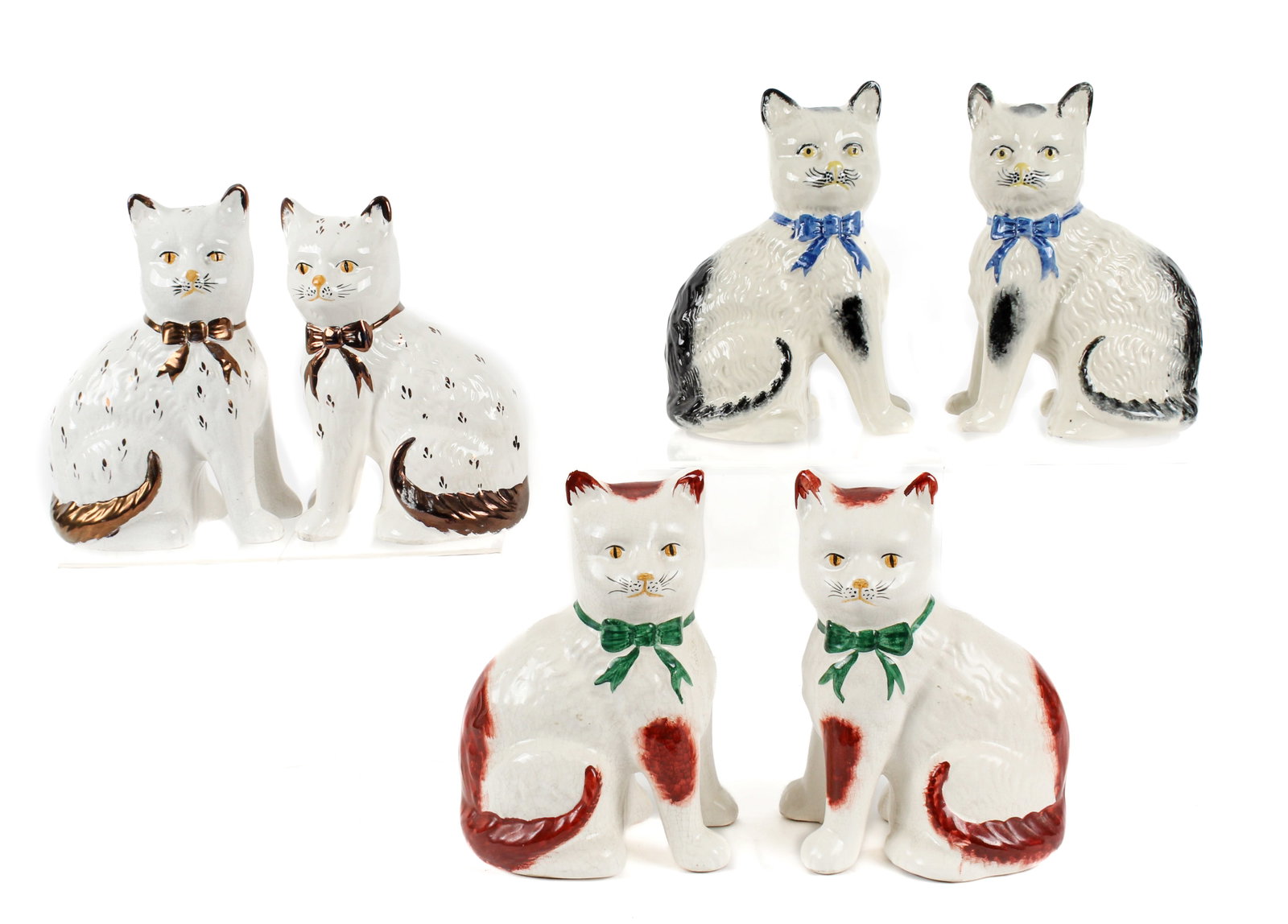 Six Hand-Painted Staffordshire Cat Figurines: Description: Three pairs of hand-painted Staffordshire seated cat figurines. The first pair from the mid-20th century with green bows and yellow eyes. The second pair, likely 19th century, with yellow