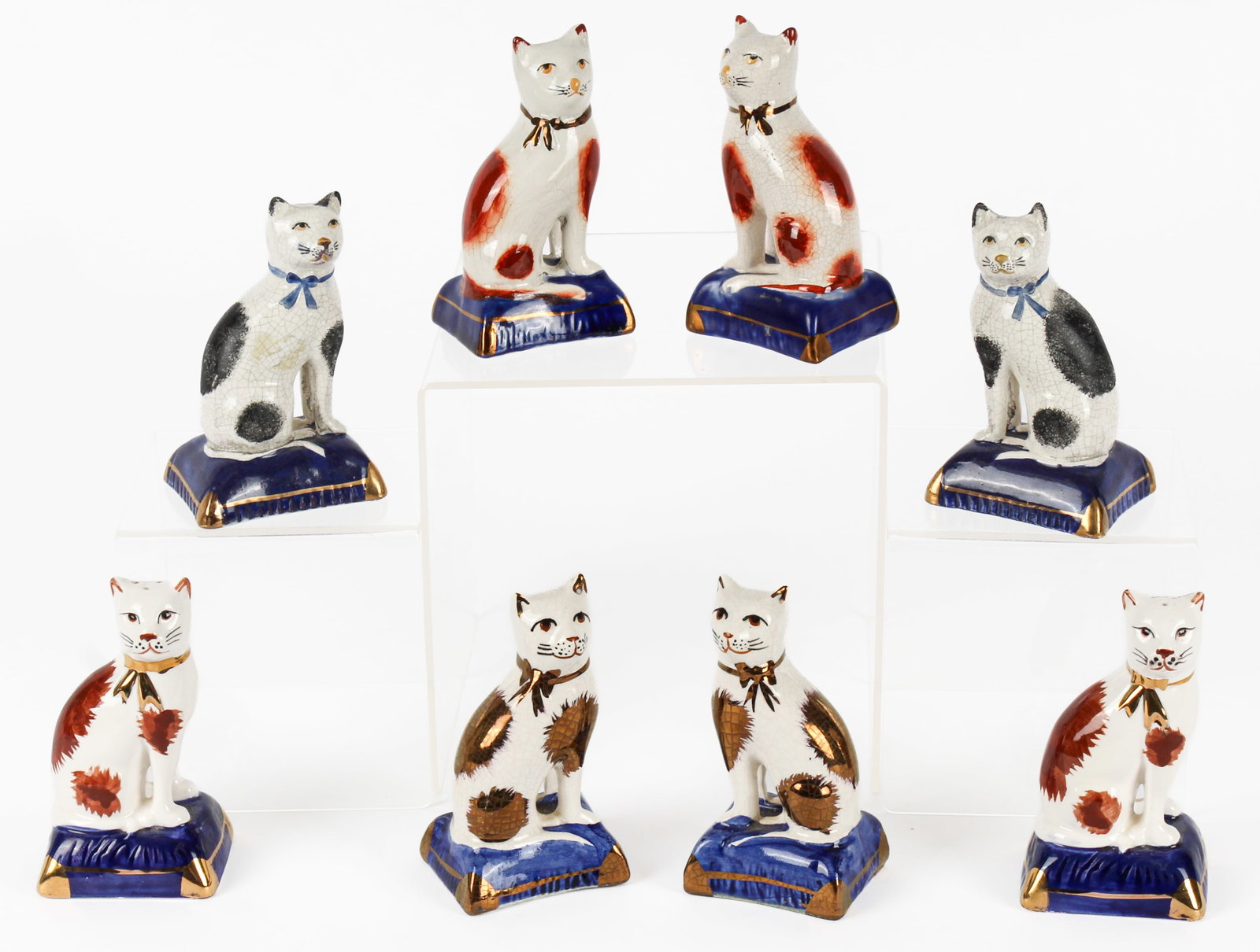 Six Hand-Painted Staffordshire Cat Figurines, Pair of Staffordshire Style Seated Cat Salt and Pepper: Description: Three pairs of hand-painted Staffordshire seated cat figurines. The first pair with gold lustre bows and accents. The second pair with gold lustre bows and reddish-brown accents. The thir