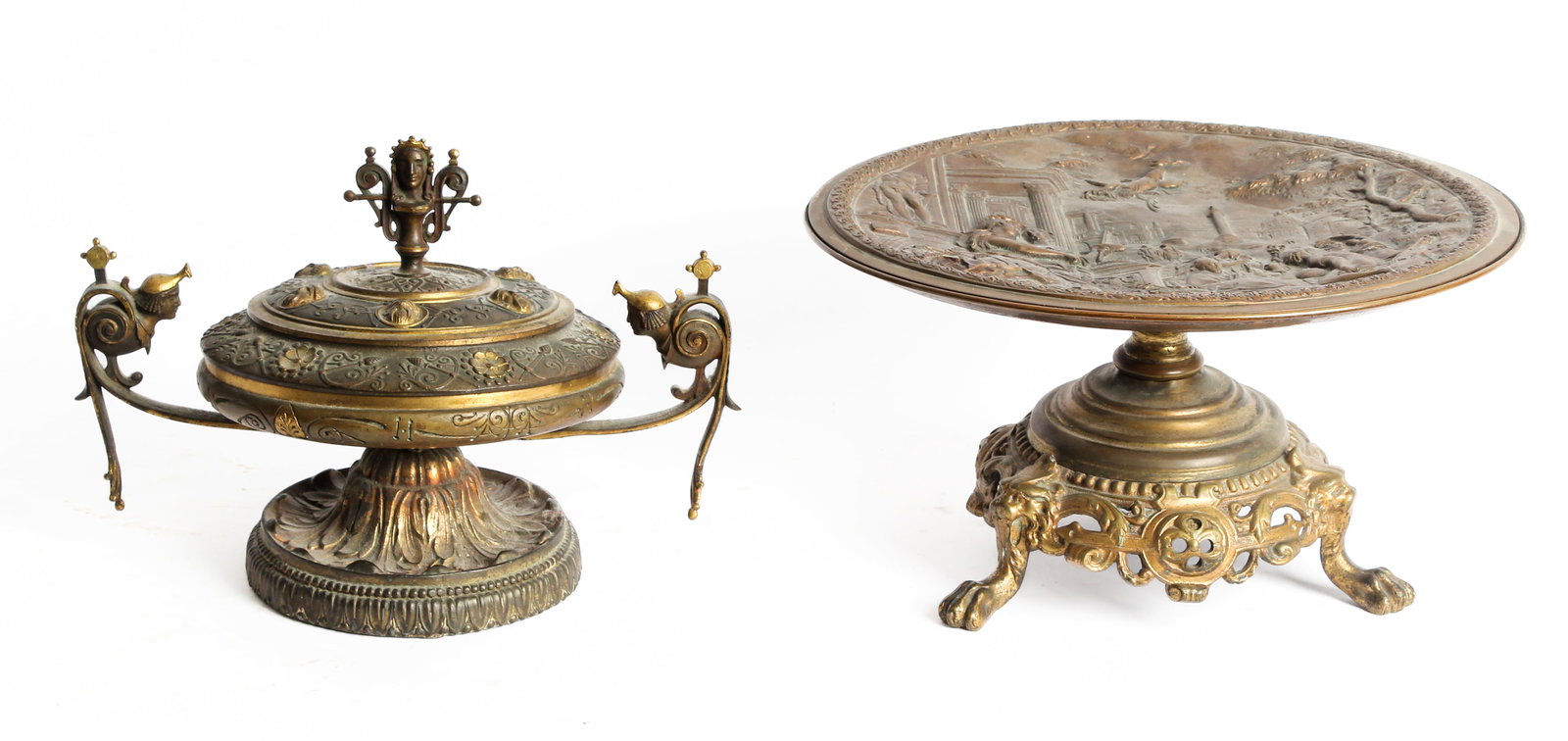 19th Century Neoclassical Bronze Bas Relief Tazza, Lidded Vessel: Description: A Neoclassical bronze tazza with a bas relief plaque depciting a Greco-Roman scene, on a presumably later bronzed spelter pedestal base with openwork design and supported by lion's heads