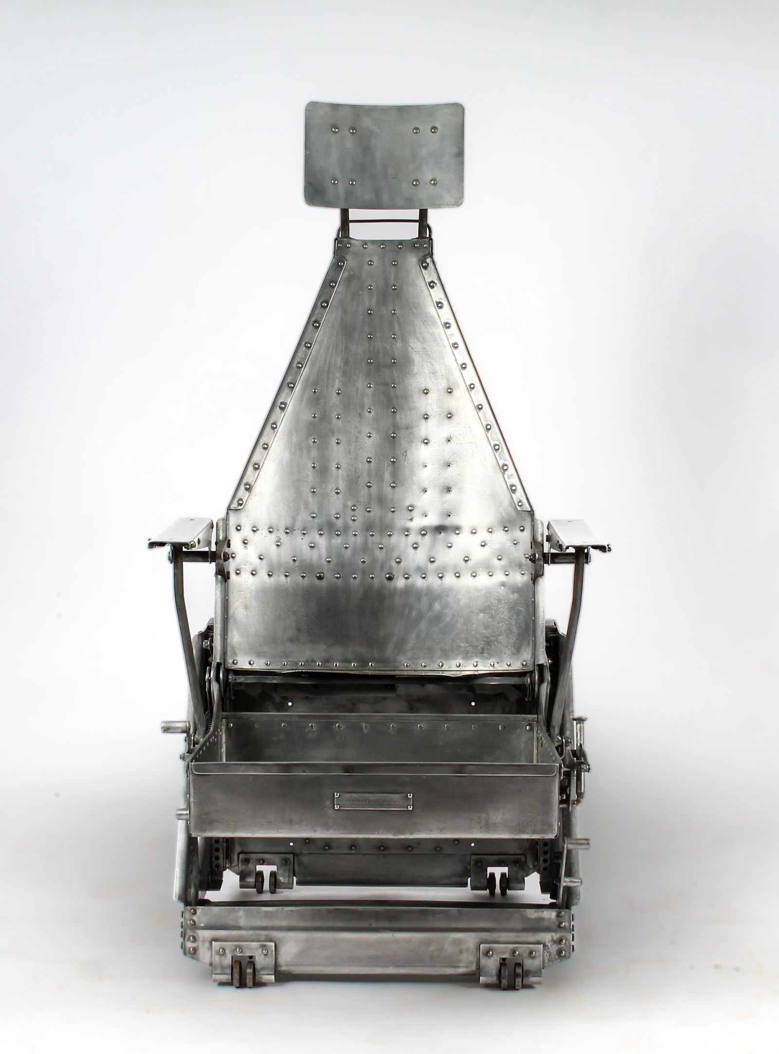 1950s Aircraft Mechanics Inc. USAF Pilot's Adjustable Seat for Long Range Aircraft Type II: Description: U.S. Air Force pilot's adjustable seat for long range aircraft type II. Riveted metal frame with headrest. Manufacturer's plaque verso. Markings & Inscriptions: MarkedDate: 1950s Maker: A