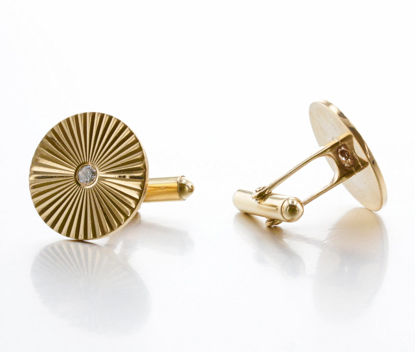 14K Gold and Diamond Fluted Sun-Ray Vintage Cufflinks: Description: A pair of Art Deco-style engine-turned fluted sun ray-patterned diamond cufflinks, each set with a flush-set diamond. Estimated carat weight: 0.16 Ctw. Markings & Inscriptions: stamped "1