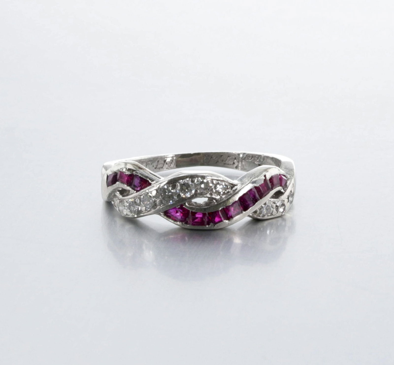 Bailey, Banks & Biddle Platinum, Diamond, and Ruby Ring: Description: A Platinum and diamond anniversary ring set with eleven round-cut diamonds, and channel-set square-cut rubies. Markings & Inscriptions: Engraved: "C.H.B M.B1929-1954" Makers Mark: "BBB" B