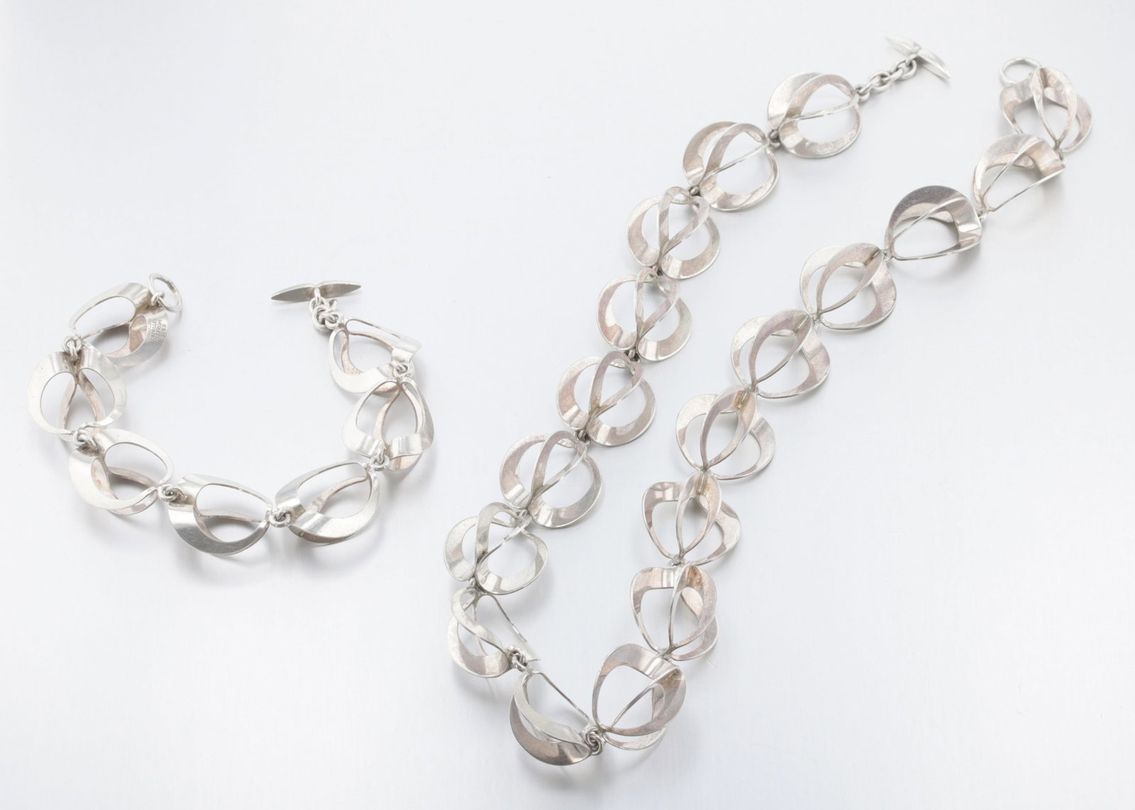 Niels Erik From (N.E From) Bracelet and Necklace Set: Description: A sterling silver N.E From three-dimensional circle link bracelet and a matching necklace set with toggle clasps. Markings & Inscriptions: Signed "N.E From "Sterling, Denmark" Date: Mid-2