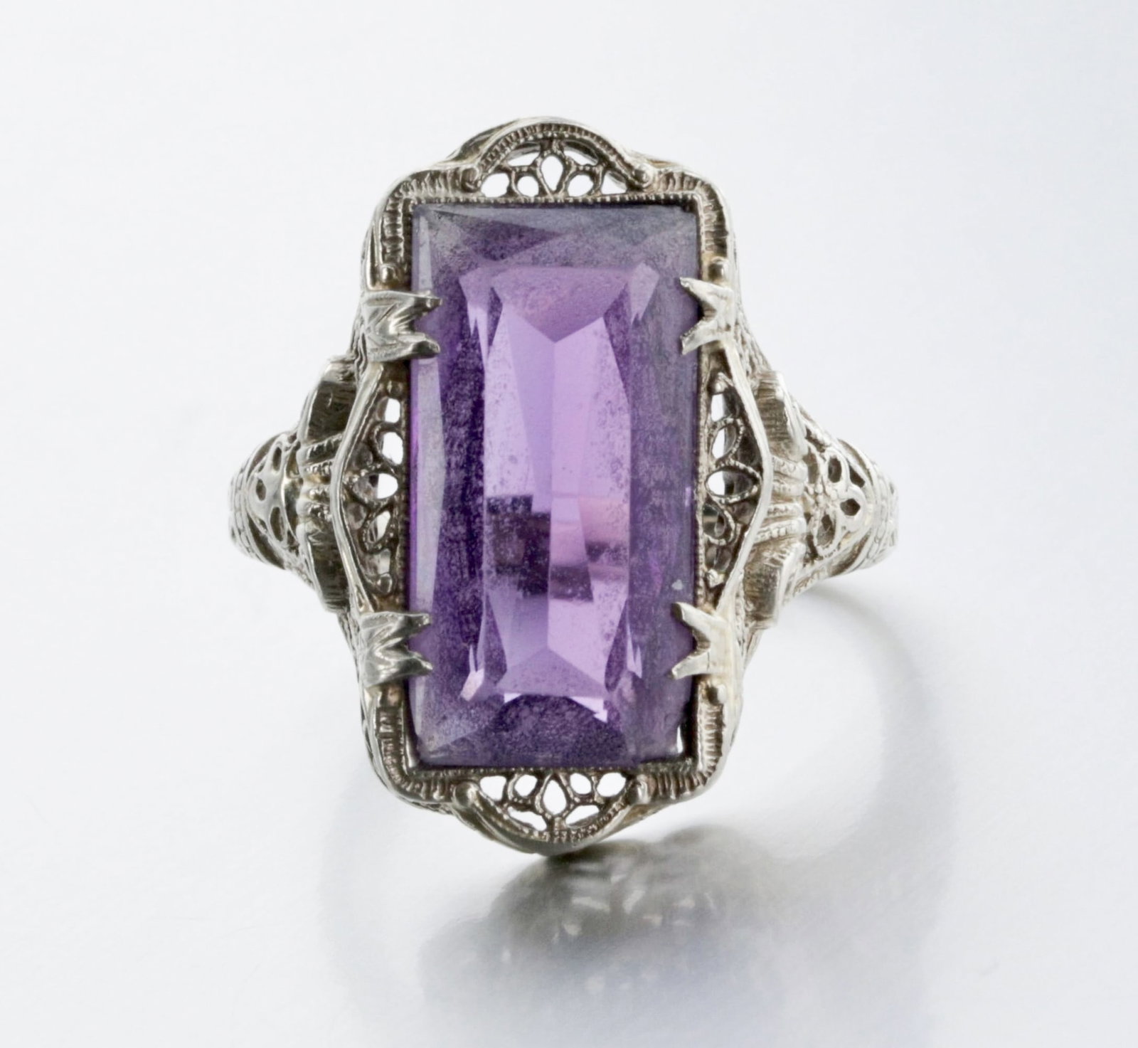14K White Gold Art Deco Amethyst Ring: Description: Ladies Art deco ring with an elongated 16x8mm, Amethyst, white gold, filigree pieced style, Markings & Inscriptions: "14K" and maker's mark (double inverted triangle). Date: 1920's Art De