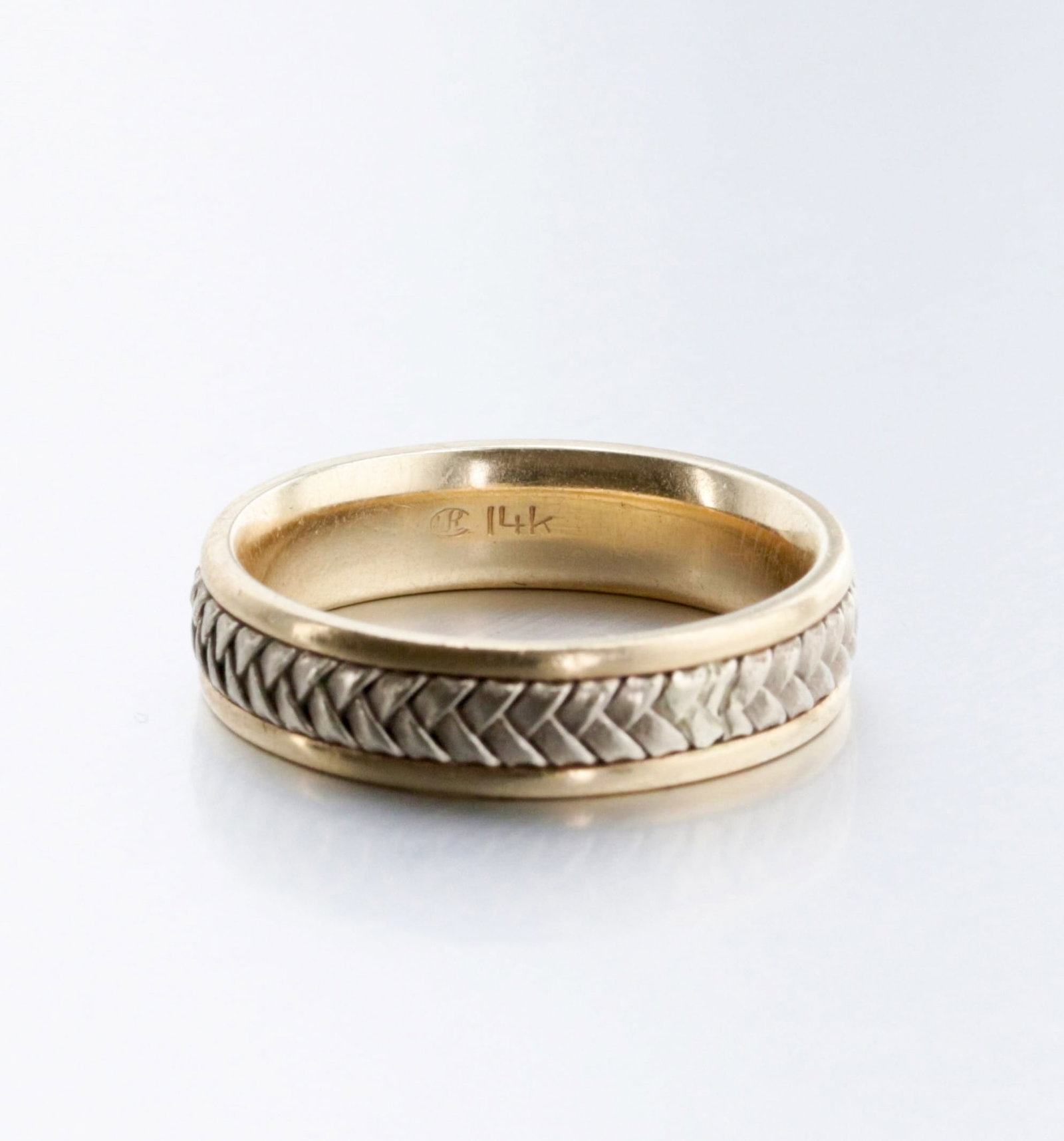 14K Gold Two-Tone Gold Band: Description: A 5mm bi-color 14 K yellow gold band with an inlaid white gold woven pattern in the center. Markings & Inscriptions: "14K" and "WR" maker's mark. Date: Contemporary Maker: unknown signed 