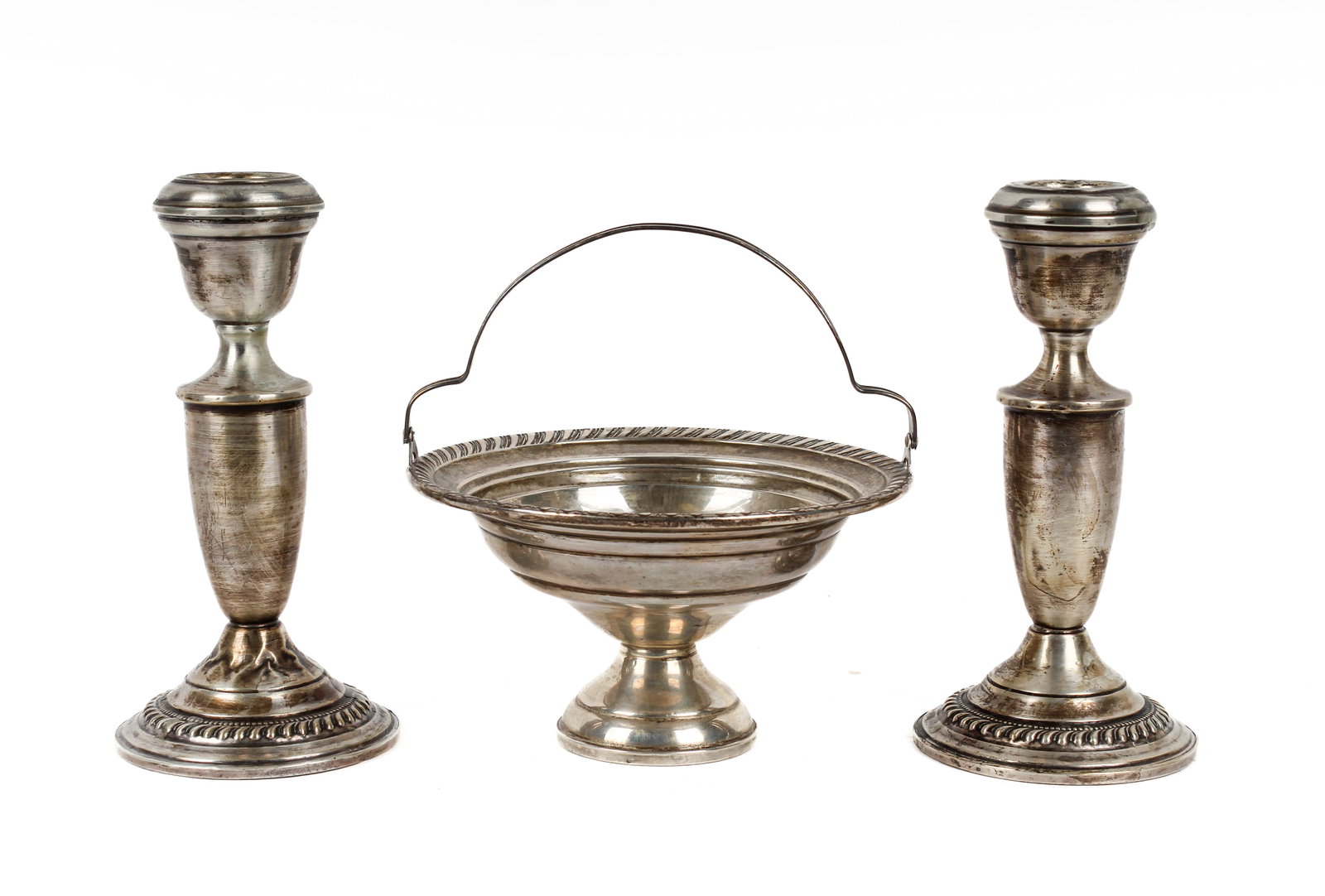 Group of Weighted Sterling Silver Items: Description: Group of weighted sterling silver items including a handled compote by Luraline and a pair of Arrowsmith candlesticks. Markings & Inscriptions: Marked to the undersides Date: Early to mid