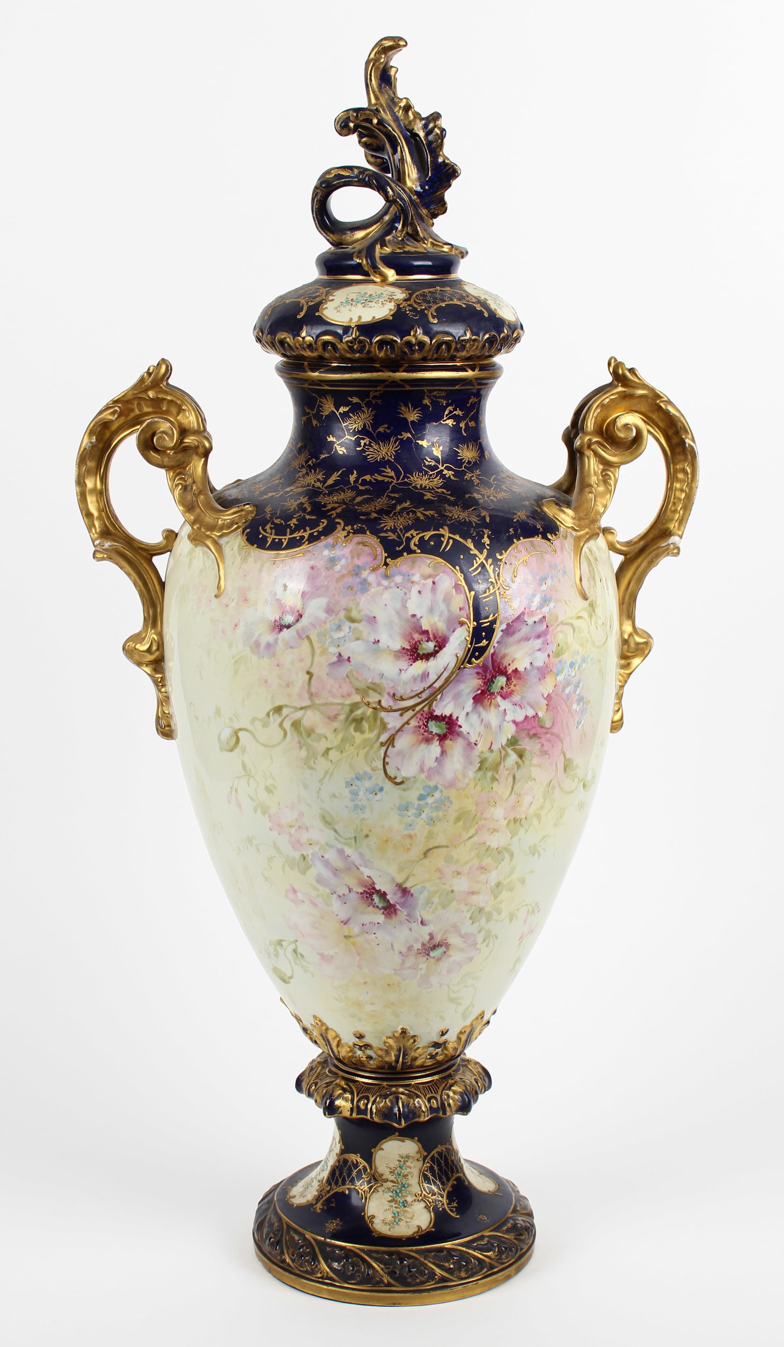 Large Franz Anton Mehlem Royal Bonn Hand Painted Porcelain Handled Urn: Description: A large urn or handled vase decorated with hand painted flowers and gilt elements, on a rounded base. Markings & Inscriptions: Marked Date: Early 20th century Maker: Royal Bonn Dimensions