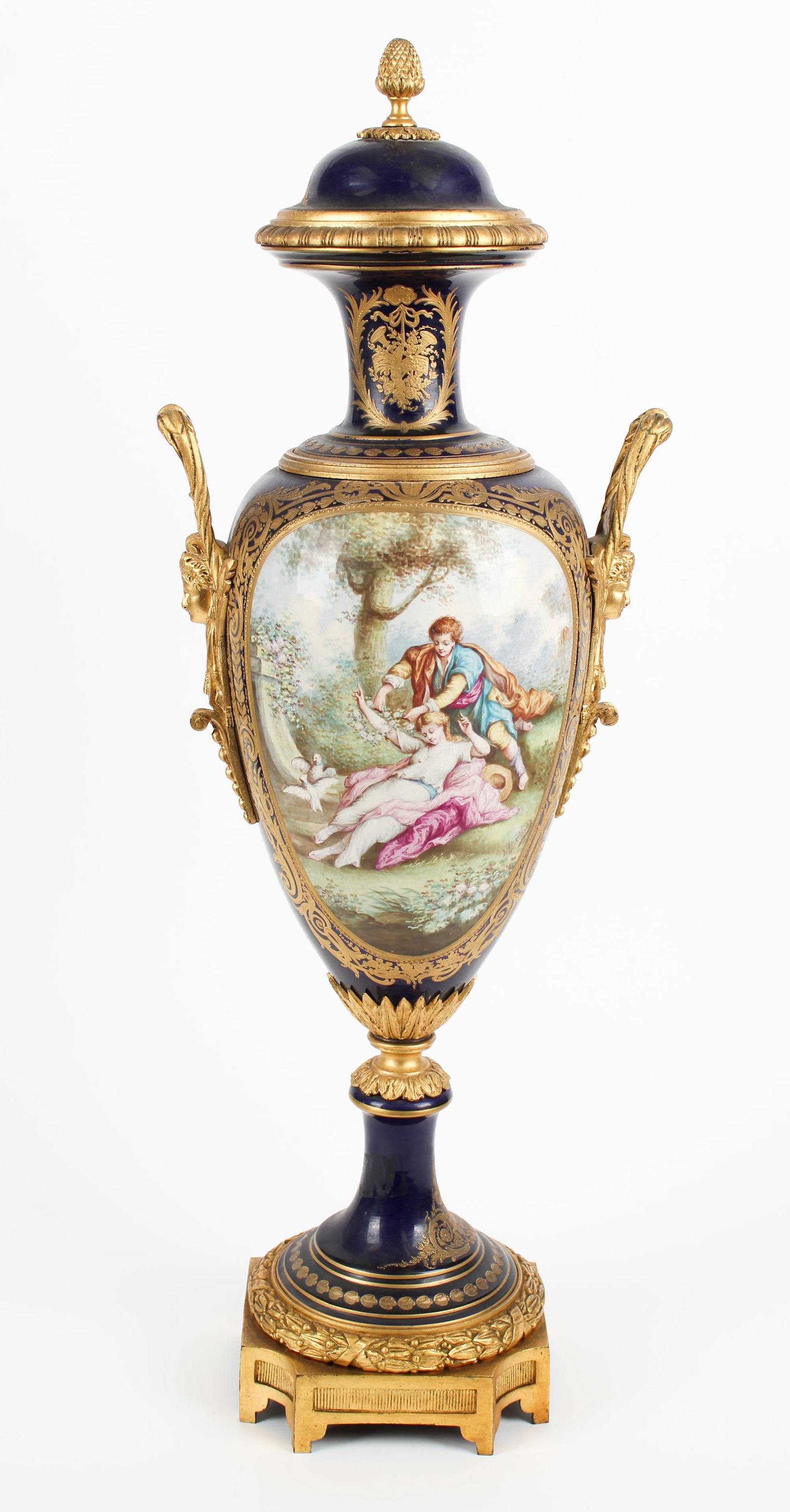 Large Sevres Style Ormolu Bronze Mounted Porcelain Urn, L. Bertren: Description: A large Sevres style French porcelain bronze mounted cobalt ground urn with hand painted courting scene and surface gilt decoration. Markings & Inscriptions: Marked Date: Late 19th/early 
