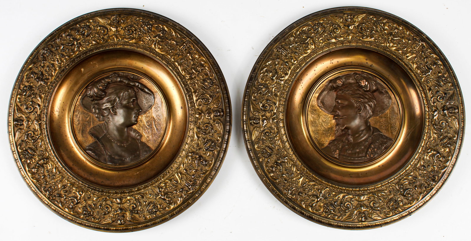 Hugo Heck, German Bronze Renaissance Portrait Wall Plaques: Description: Two bronze wall plaques decorated with a Renaissance-era man and woman, within Renaissance-style relief decorated borders. Markings & Inscriptions: Marked verso Date: Ca. 1900 Maker: Hugo