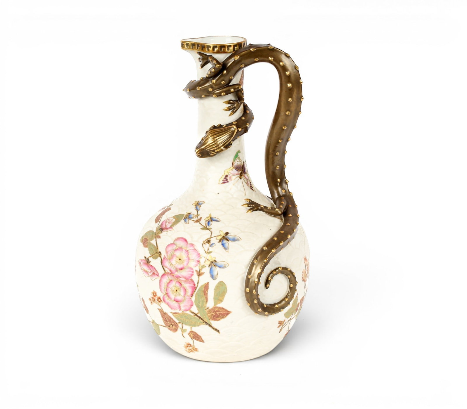 Royal Worcester Blush Ivory Porcelain Dragon Pitcher: Description: A porcelain pitcher in Blush Ivory, decorated with flowers and butterflies, having a figural dragon handle. Additional Royal Worcester items from the estate of Stuart Brown will be featur