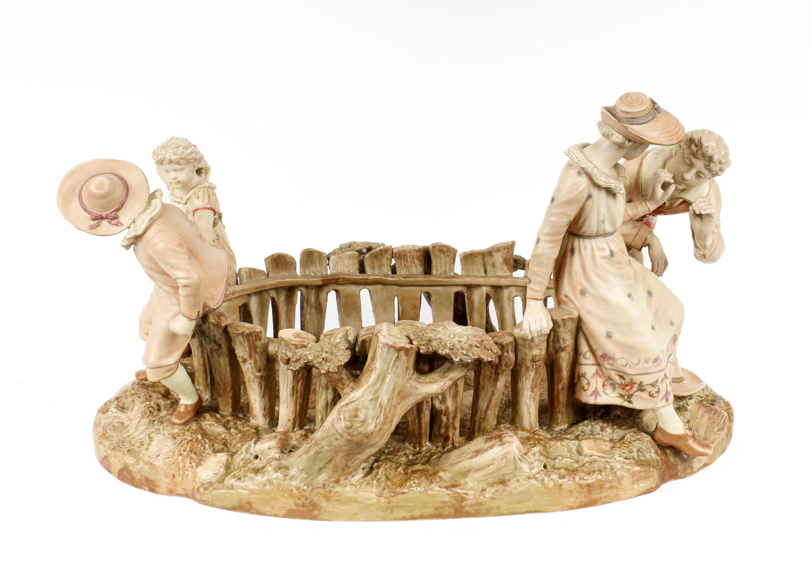 Royal Worcester Porcelain Centerpiece, James Hadley: Description: A large porcelain figural centerpiece modeled by James Hadley, decorated with a courting couple and playing children beside a fence. Additional Royal Worcester items from the estate of St