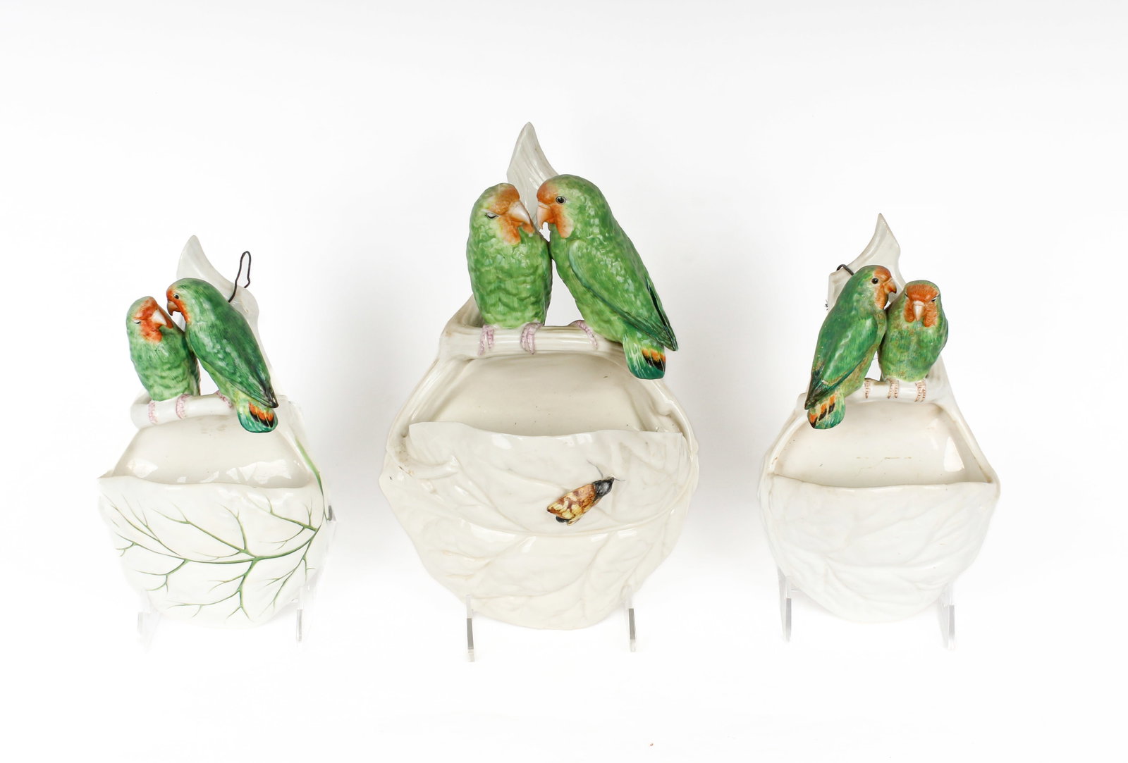 Three Royal Worcester Majolica Lovebird Wall Pockets, Incl. Tiffany & Co.: Description: Group of three Royal Worcester majolica lovebird wall pockets. Each with two green and orange glazed birds on a branch and a leaf form pocket. One marked 'For Tiffany & Co. New York' vers