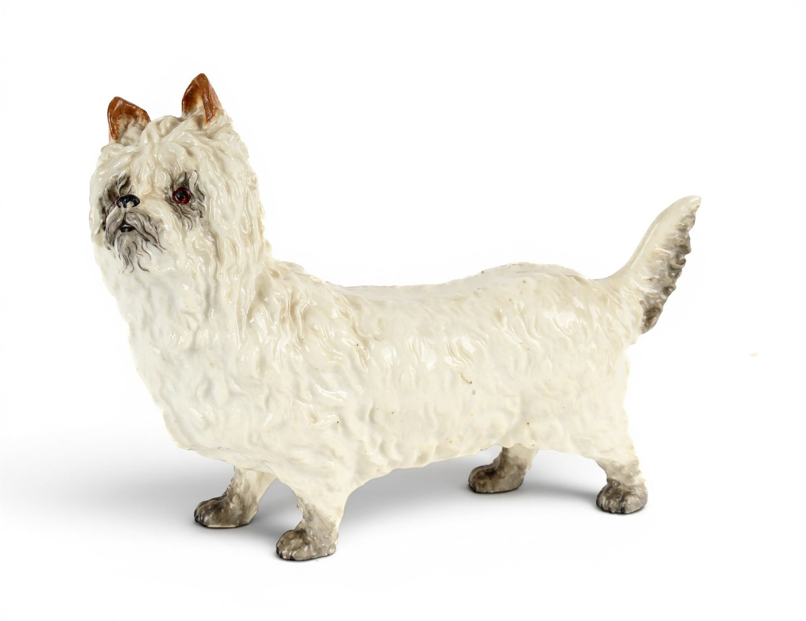 Royal Worcester Porcelain Figurine of a West Highland Terrier: Description: Royal Worcester porcelain figurine of a standing West Highland terrier with brown tipped ears. Additional Royal Worcester items from the estate of Stuart Brown will be featured in our upc