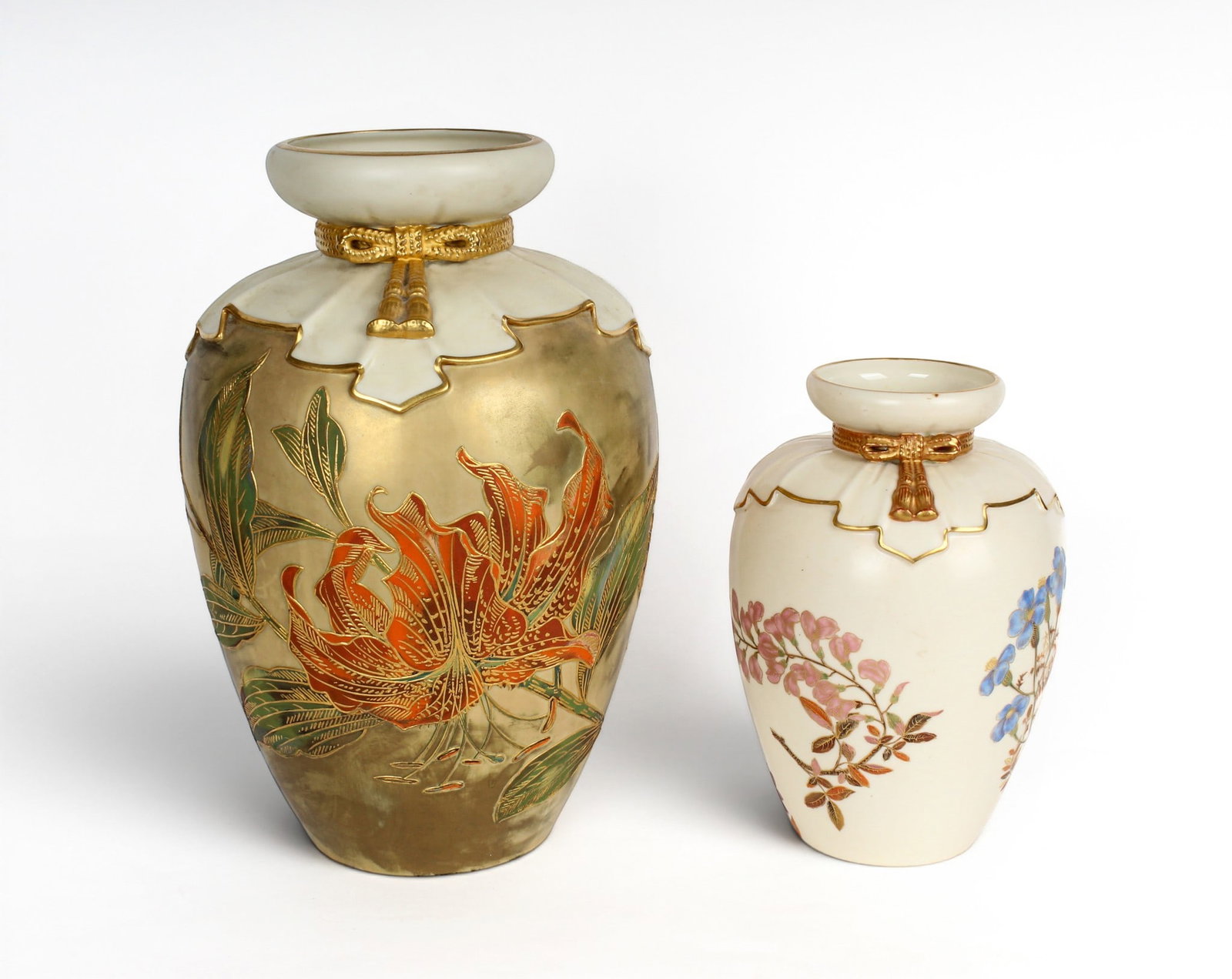 Two Royal Worcester Porcelain Patent Metallic Napkin Vases: Description: Two Royal Worcester porcelain patent metallic napkin vases. Both with gilt painted corded tassel around the 'napkin' gathered neck. The taller vase decorated with tiger lilies on a mottle