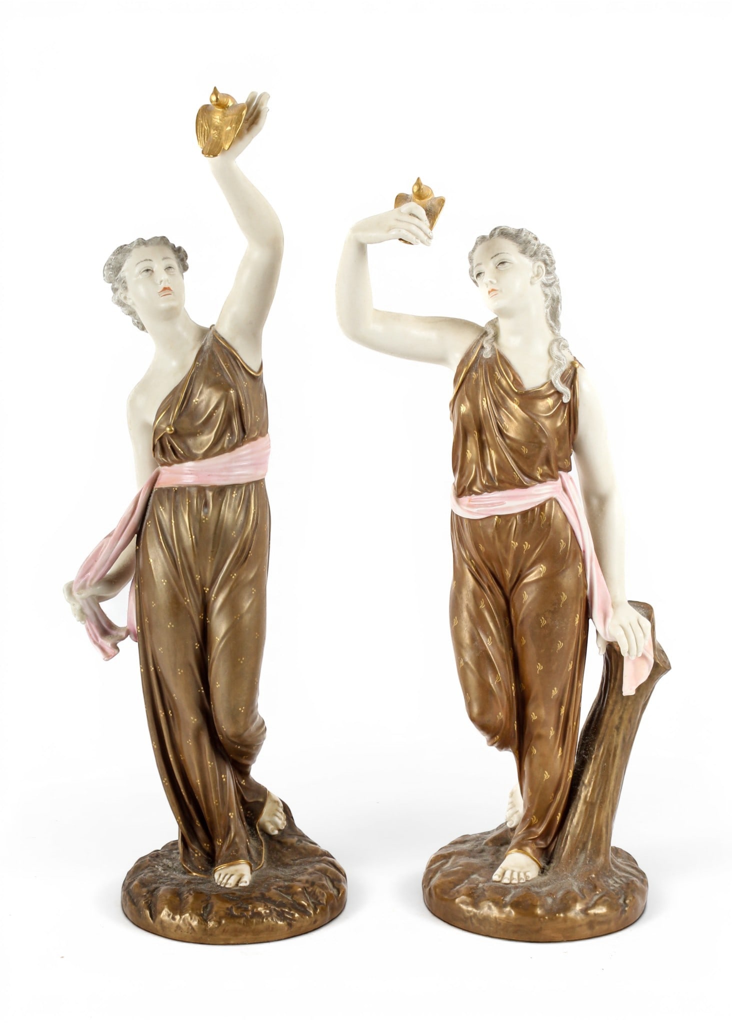 Royal Worcester Porcelain Figures of Liberty' and 'Captivity: Description: Two Royal Worcester porcelain figures titled 'Liberty' and 'Captivity'. Both female figures modeled in draped gowns and holding gilded birds, 'Liberty' letting hers go and 'Captivity' hol