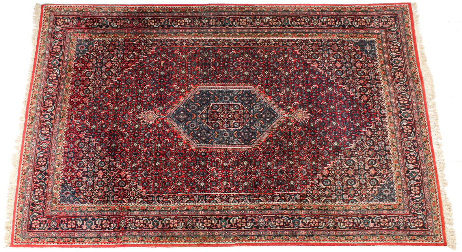 Persian Bidjar Area Rug, 6' x 9.5': Description: A hand knotted Bidjar area rug in primarily red and blue tones, decorated with geometric and naturalistic motifs. Markings & Inscriptions: Unmarked Date :Late 20th century Maker: Persian/