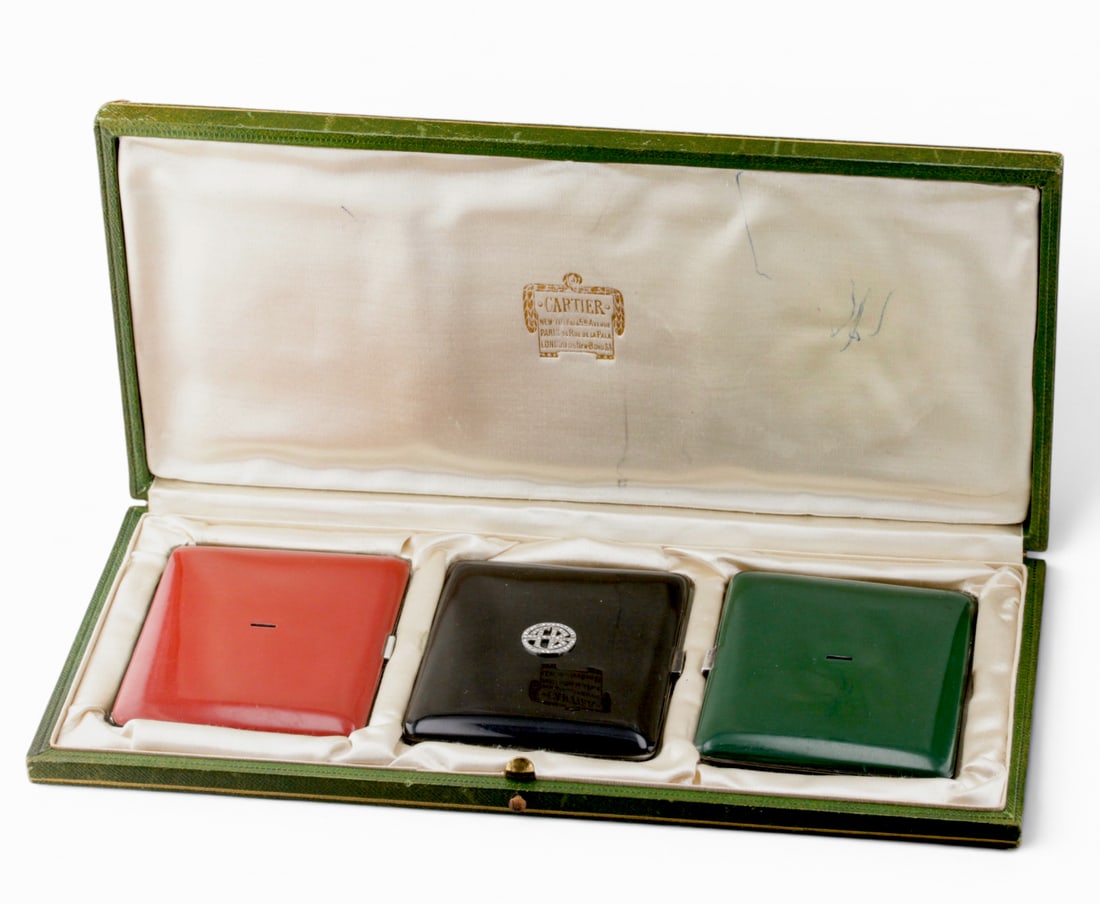Set Of Cartier Art Deco Jeweled Gilt Silver Cigarette Cases: Description: A three-piece Art Deco set of Cartier jeweled, lacquered enamel cases, made of gilt sterling silver, in the original Cartier presentation box. Removable/interchangeable rose-cut diamond m
