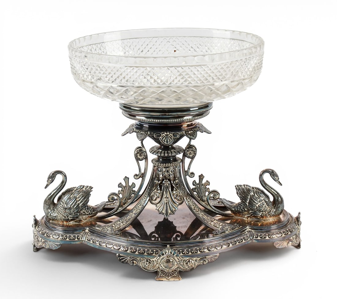 Elkington & Co. Victorian Silverplate and Glass Centerpiece: Description: Large Elkington & Co. Victorian silverplate centerpiece. The quatrefoil lobed base, raised on four feet with flanking swans. Surmounted by an oval cut glass bowl, raised on intricate supp