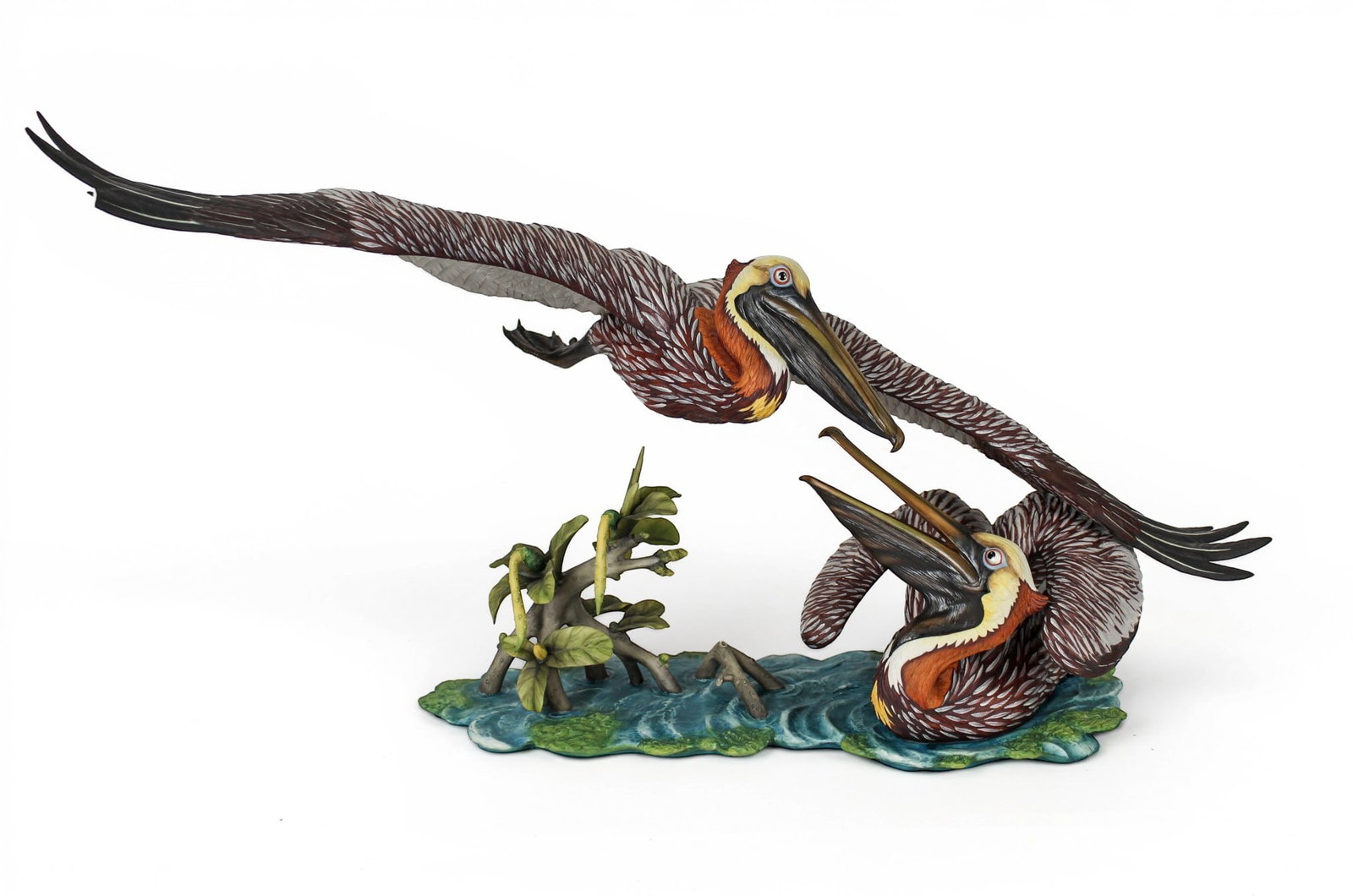 Goebel Gunther R. Granget Hand-Painted Porcelain Grouping "Language of Nature": Description: Goebel limited edition polychrome hand-painted porcelain grouping titled "Language of Nature" depicting a male and a female Brown Pelican in naturalistic water setting with leaves and woo