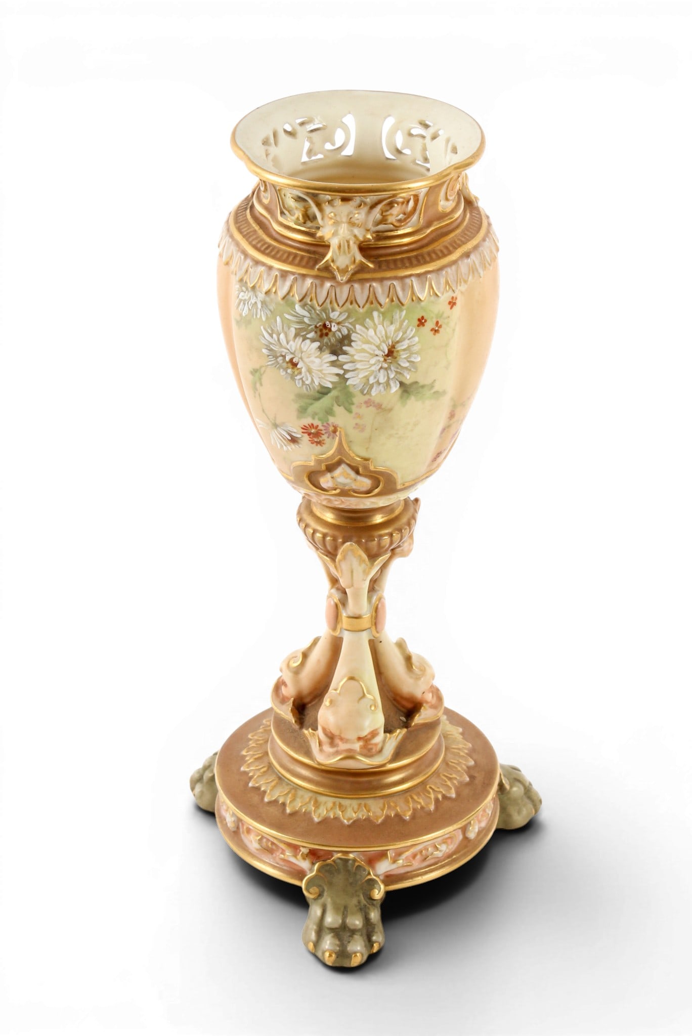 Royal Worcester Footed Porcelain Vase: Description: A porcelain footed vase with figural dolphin stem and hand painted flower bowl, the pierced rims decorated with mythical faces, all above a circular base raised on three paw feet. Shape 1