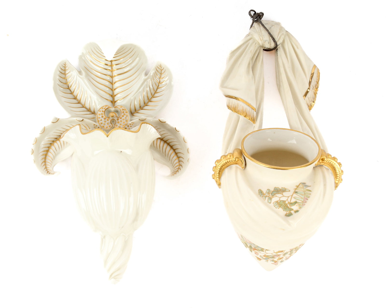 Two Royal Worcester Porcelain Wall Pockets: Description: Two Royal Worcester porcelain wall pockets. The first, modeled as an urn being hung by a tied scarf. The urn decorated with gilt accented flowers, gilt handles, and gilt tasseling to the 