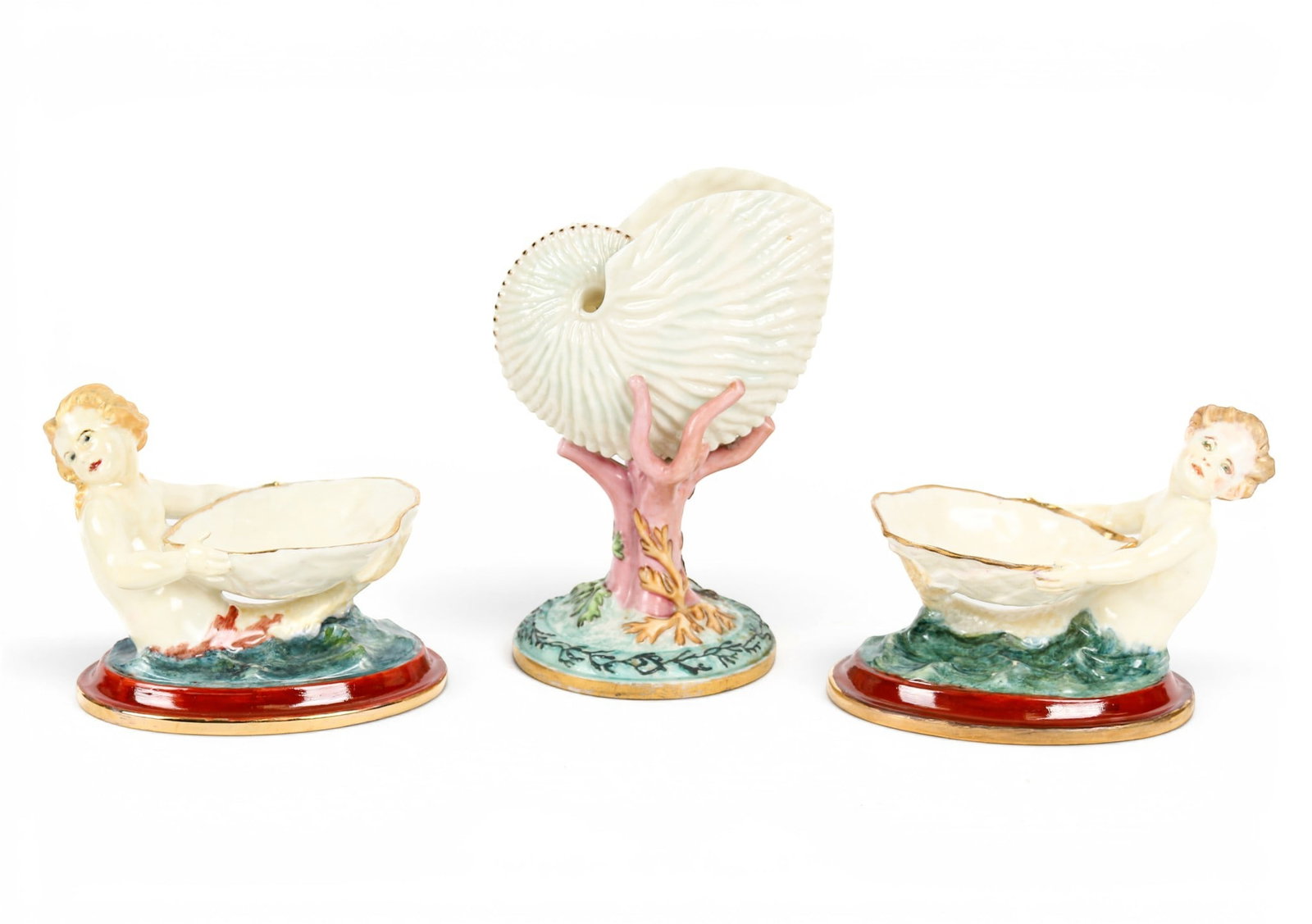 Pair of Royal Worcester Porcelain Mermaid Salts: Description: Pair of Royal Worcester porcelain polychrome glazed salts each modeled as a mermaid or merboy holding a scallop shell on an oval base. Shape number 349. Together with a Royal Worcester po