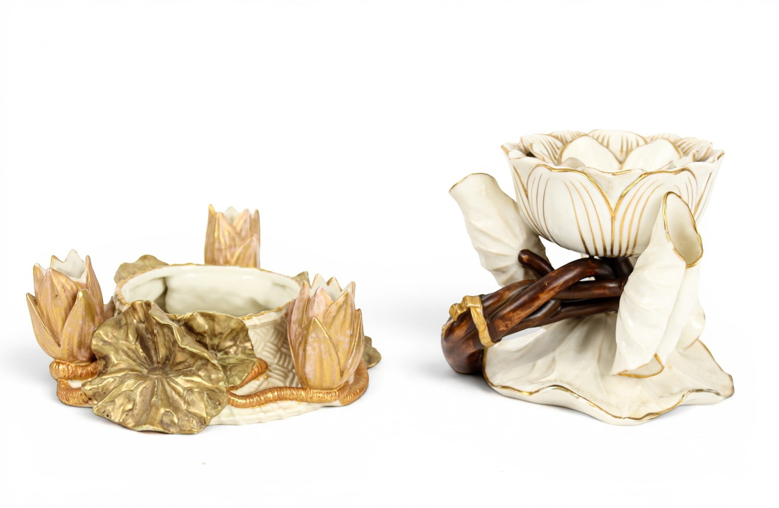 Two Royal Worcester Porcelain Lotus Flower-Holders: Description: Two Royal Worcester porcelain, gilt accented lotus flower-holders. The first with a central lotus flower on a naturalistic base of stems and flower petals. The second, modeled as three lo
