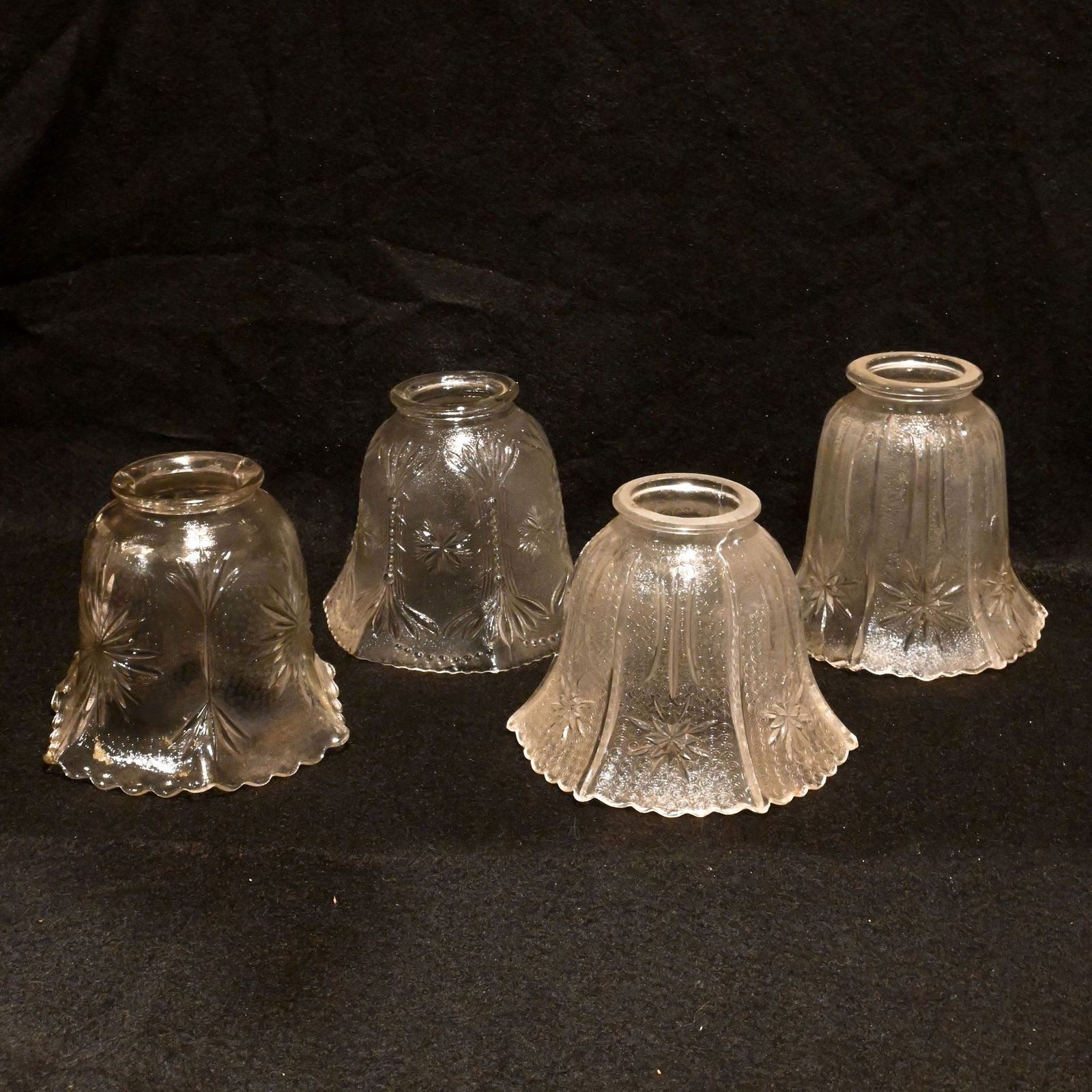 Group of four 2 1/4" fitter clear gas/electric pressed glass shades with various patterns (1 of 5)