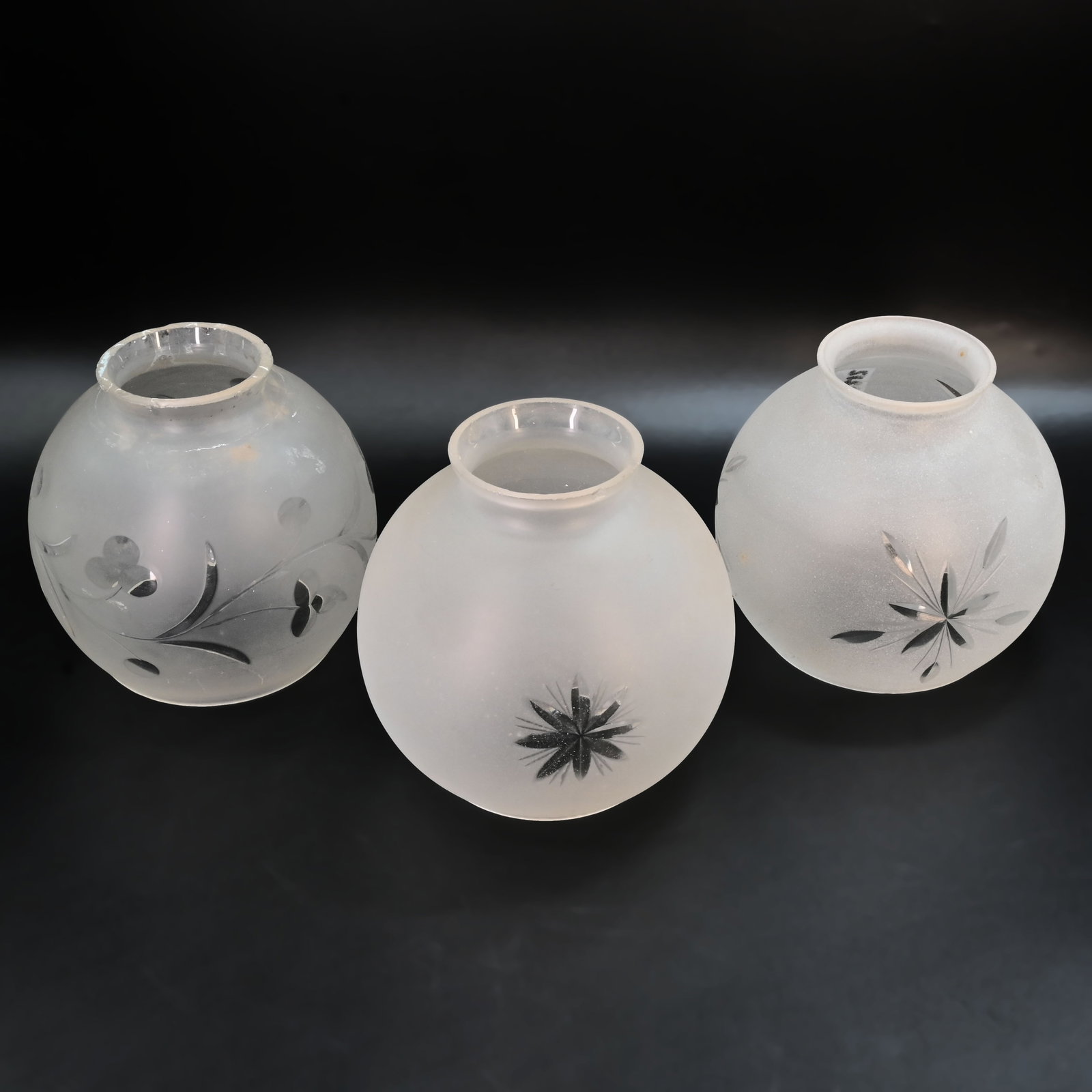 Group of three 2 1/4" fitter cut glass gas/electric globe shades: Group of three 2 1/4" fitter cut glass gas/electric globe shades. Left: 4" tall x 4 1/2" diameter. Middle: 4 1/4" tall x 4 1/2" diameter. Right: 4 1/4" tall x 4 1/2" diameter.