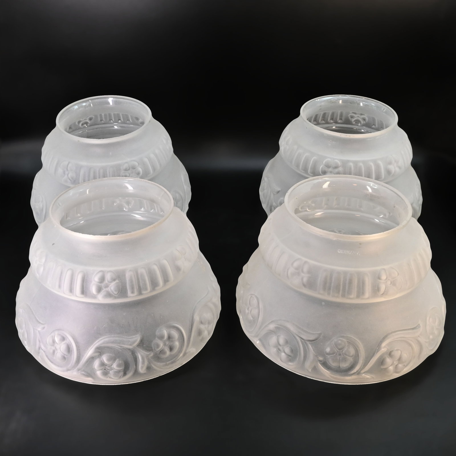 Group of four matching 4" fitter gas/electric molded frosted glass shades: Group of four matching 4" fitter gas/electric molded frosted glass shades. 4 5/8" tall x 7" diameter.