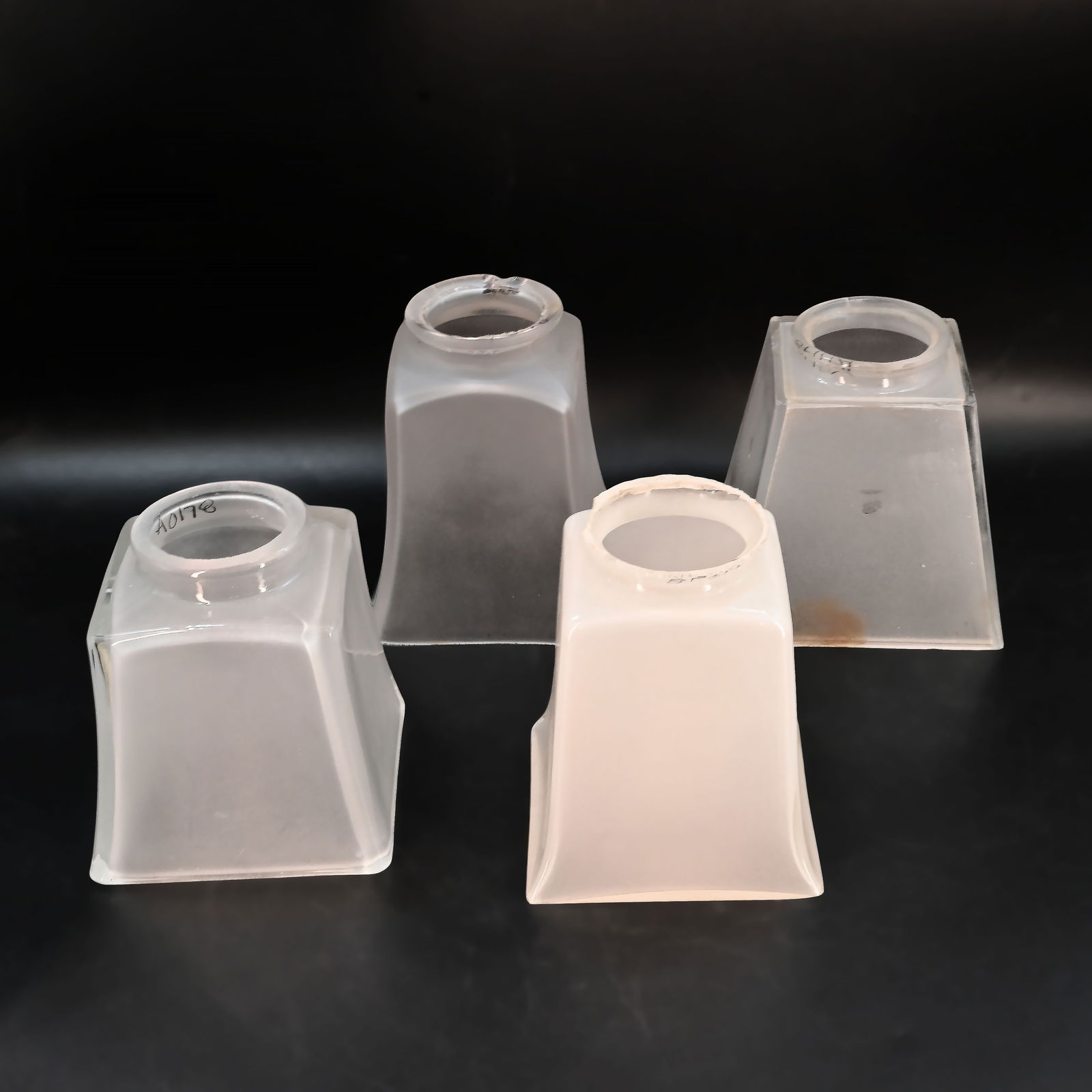 Group of four 2 1/4" fitter mission style glass shades: Group of four 2 1/4" fitter mission style glass shades. Frosted insides. Left: 4" tall x 3 3/4" square. Middle Left: 4 5/8" tall x 3 5/8" square. Middle Right: 4 3/8" tall x 3 5/8" square. Left: 4 1/4