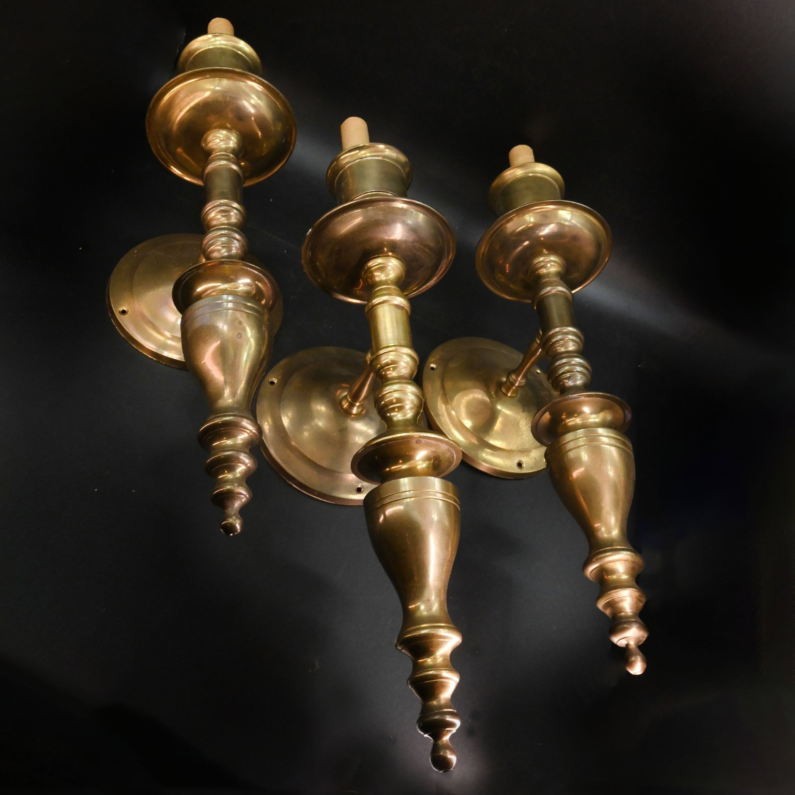 Set of three brass matching single candle tall sconces: Set of three brass matching single candle tall sconces. 17" tall x 5" wide (at backplate) x 6" projection