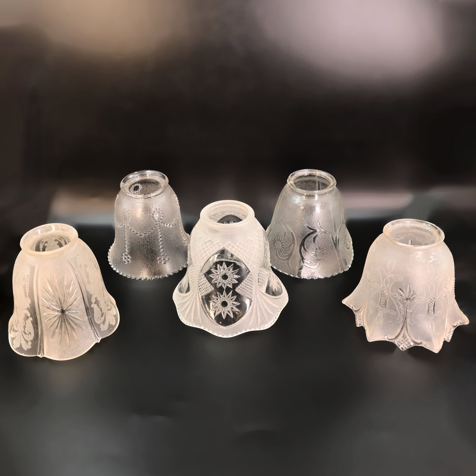 Group of five 2 1/4" fitter frosted/clear gas/electric pressed glass shades: Group of five 2 1/4" fitter frosted/clear gas/electric pressed glass shades. Left: 4 1/4" tall x 4 3/4" diameter. Middle left: 4" tall x 4 1/4" diameter. Center: 4 1/4" tall x 5" diameter. Middle Righ
