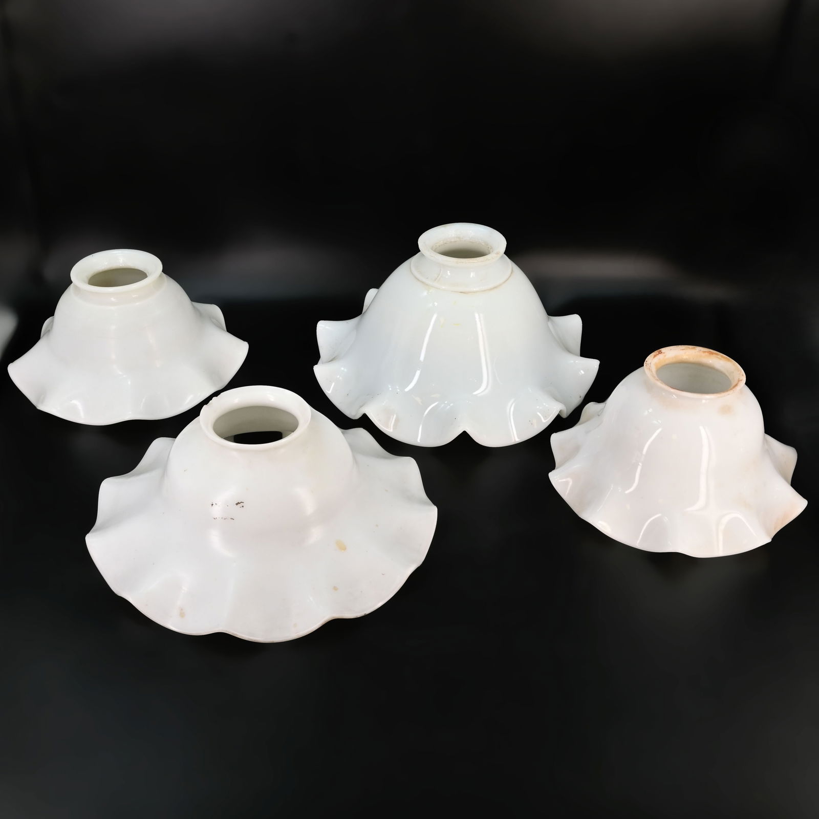 Group of four 2 1/4" fitter white glass ruffled shades: Group of four 2 1/4" fitter white glass ruffled shades. Left: 3" tall x 6" diameter. Middle Left: 2 3/4" tall x 7 1/4" diameter. Middle right: 4" tall x 7 1/4" diameter. Right: 3" tall x 5 3/4" diamet
