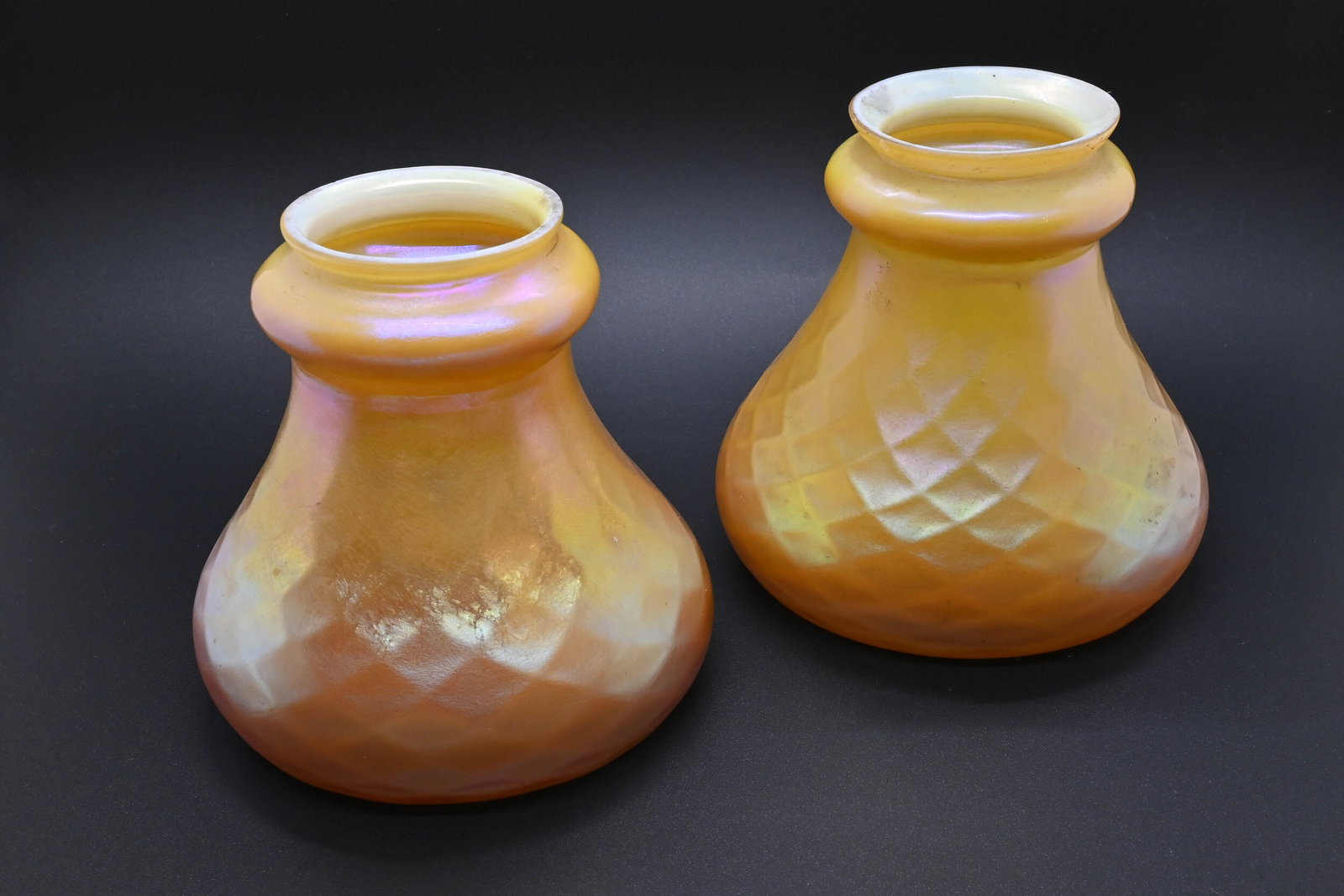 Pair of Steuben "In & Out" aurene over calcite shades: Pair of Steuben "In & Out" aurene over calcite shades. Circa: 1905. Condition: Age Consistent. Finish: Gold Aurene (exterior) / Calcite (interior). Country of origin: USA. Dimensions: 2.25” Fitt