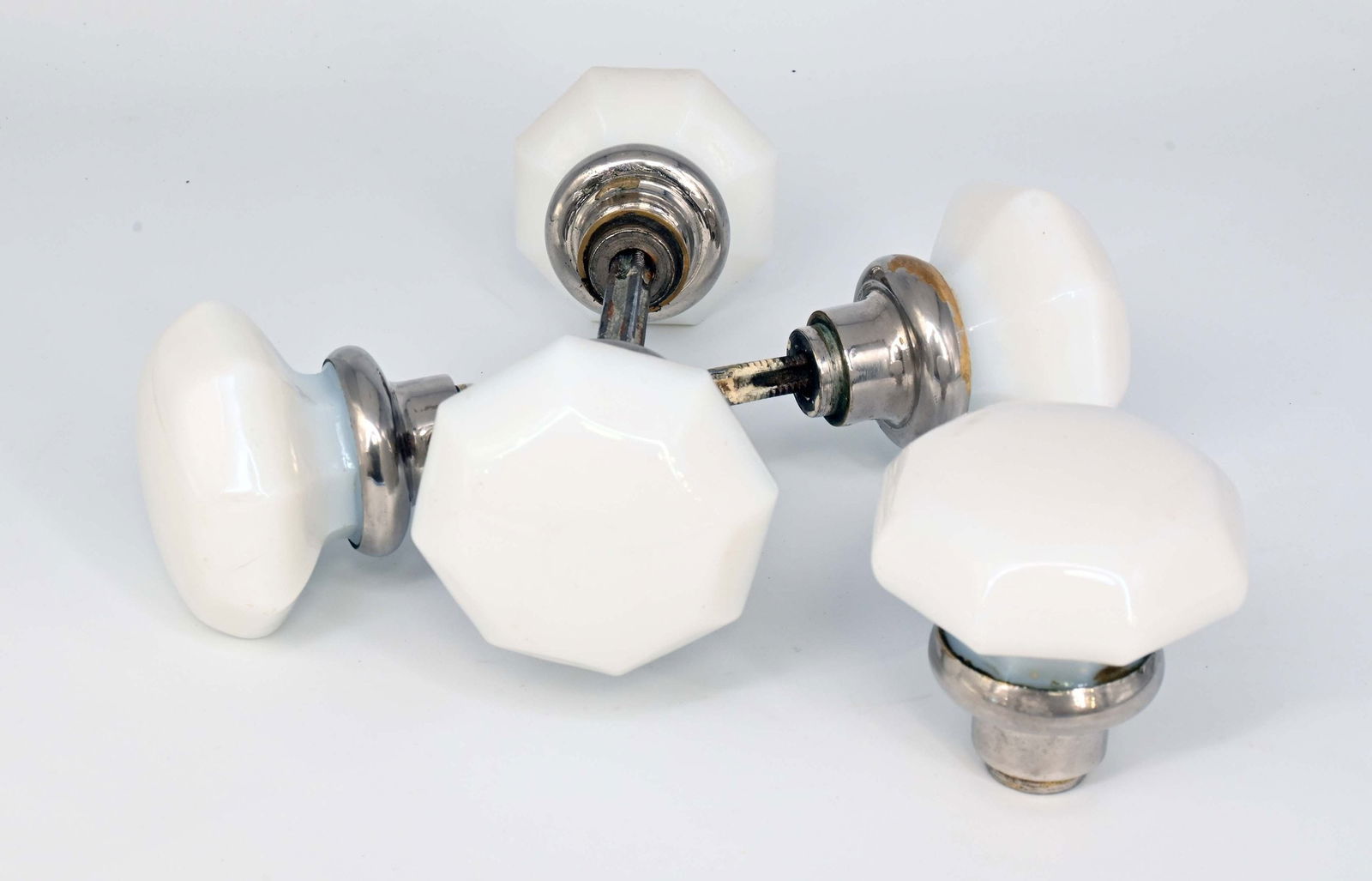 Set of four milkglass & nickel octagonal knob sets: Set of four milkglass & nickel octagonal knob sets. Circa: 1920’s. Condition: Age Consistent. Material: Milk Glass, Nickel over Brass. Finish: Original. Country of origin: USA. Dimensions:Approximat