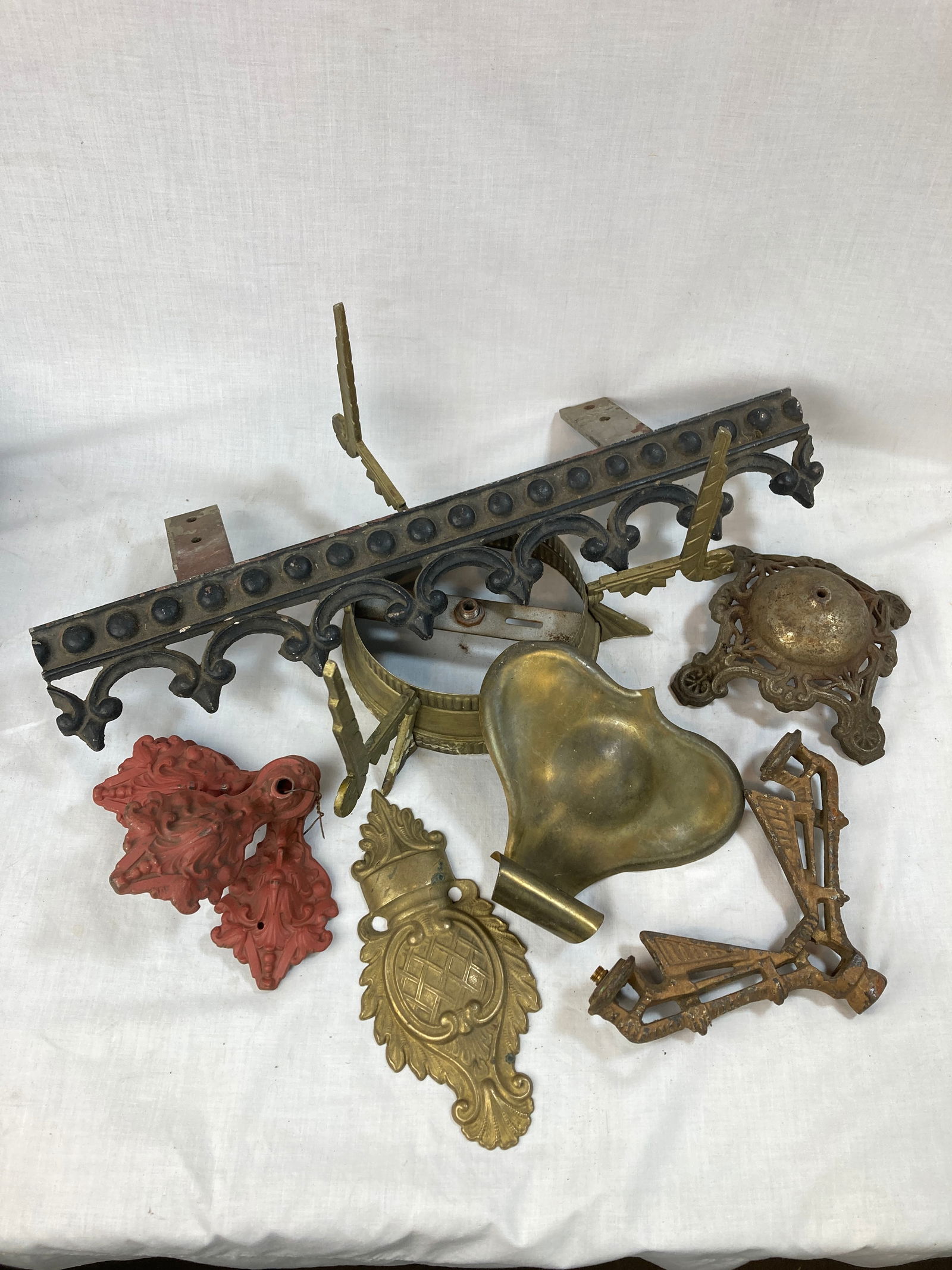 Grouping of assorted cast and stamped ornamental lighting fixture parts (1 of 2)
