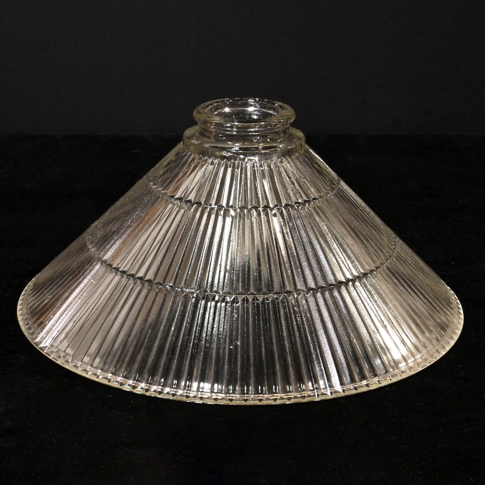 Clear cone-shaped prismatic glass shade: Clear cone-shaped prismatic glass shade. 2.25" fitter. 10" diameter x 5" tall. This item is offered with no reserve.