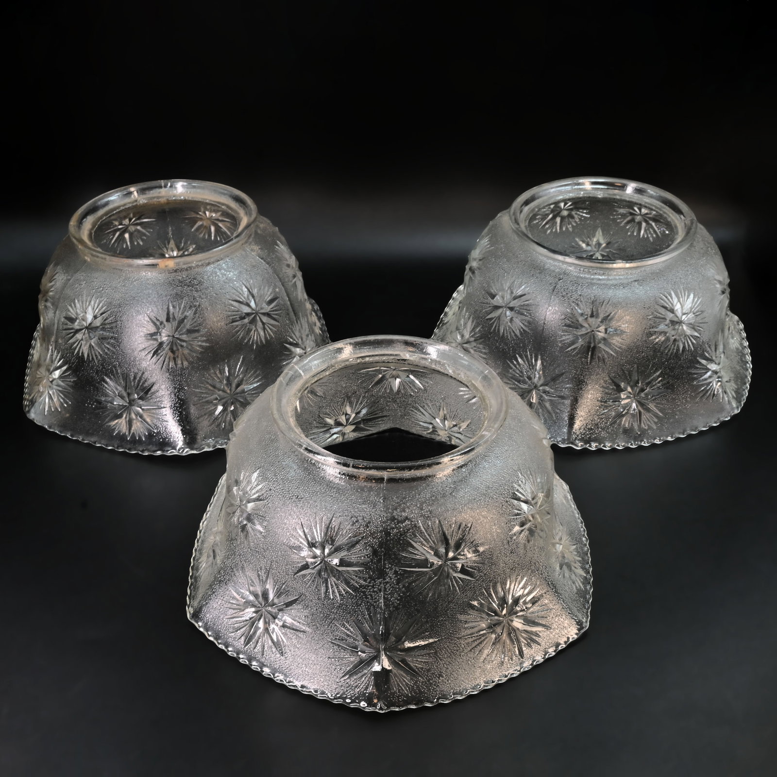 Group of three matching 4" clear cast glass gas/electric shades: Group of three matching 4" clear cast glass gas/electric shades. Approximately 3 1/2" tall x 7 3/4" diameter. This item is offered with no reserve.