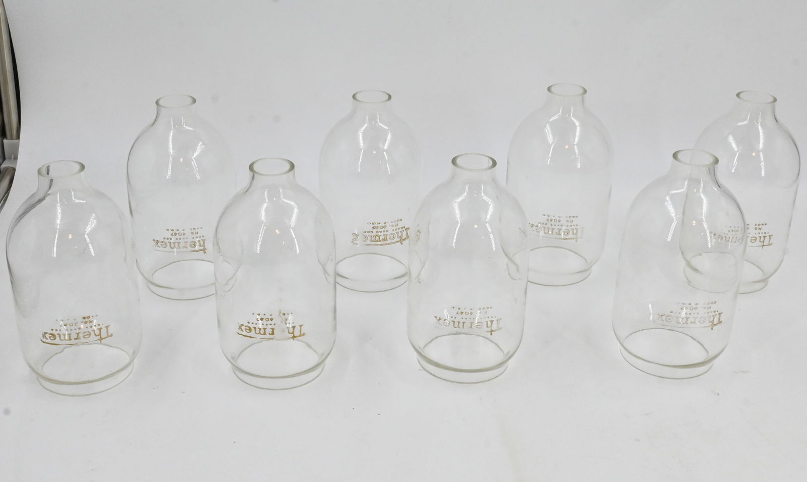 Set of 8 Thermex Arc Lamp Glass globes: Set of 8 Thermex Arc Lamp Glass globes. 7" tall x 3.5". This item is offered with no reserve.
