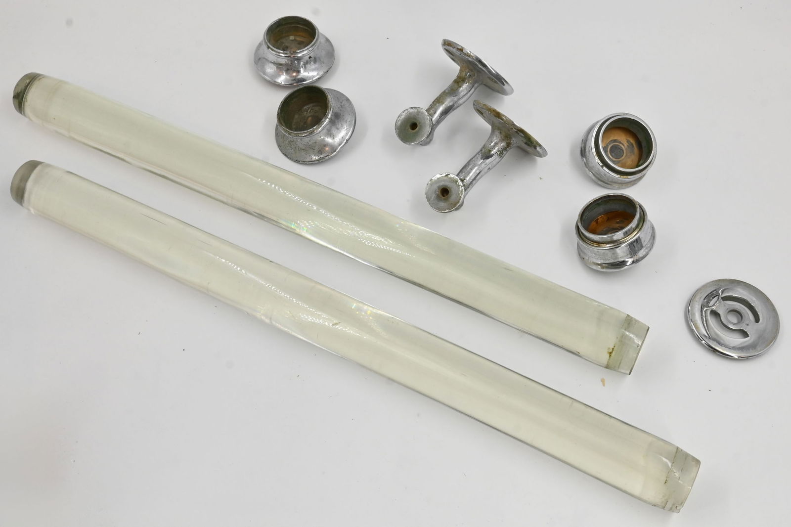Collection of thick glass rods and chrome over brass hardware: Collection of thick glass rods and chrome over brass hardware. Glass rods: 26" long x 2" diameter. Metal arms 4.25" projection x 3.5" wide x 3.25" high. End caps approximately 3" diameter x 1.75" tall