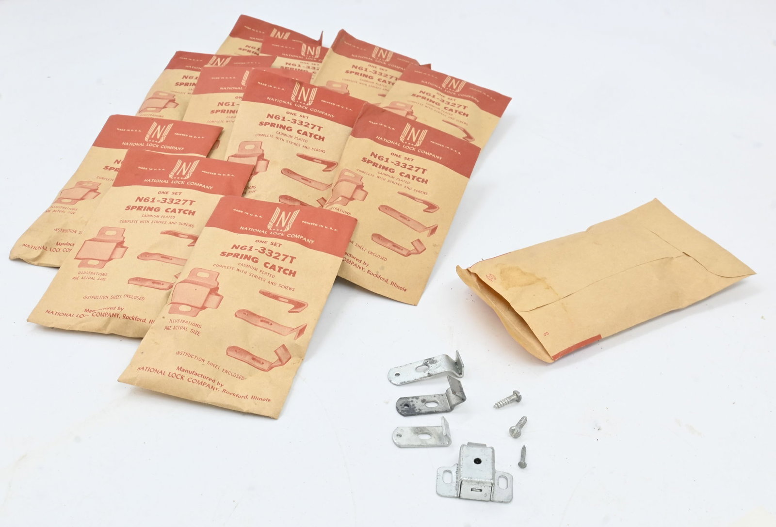 Set of twelve Old New Stock Spring catches in original packaging: Set of twelve Old New Stock Spring catches in original packaging. Cadmium plated complete with strikes and screws. National Lock Company. Made in USA. Catch measures 1.25" wide x 1" long x 0.5" deep. 
