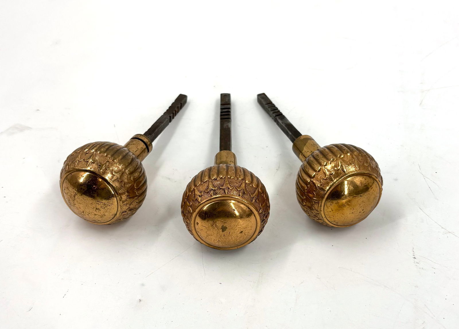 Set of three polished copper knobs with spindles and fleur de lis pattern (1 of 9)