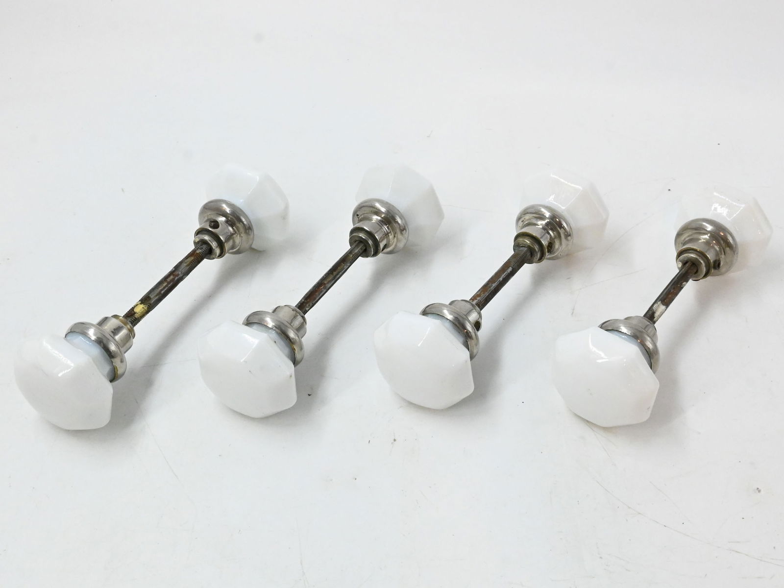 Set of four milkglass & nickel octagonal knob sets: Set of four milkglass & nickel octagonal knob sets. Circa: 1920s. Condition: Age Consistent. Material: Milk Glass, Nickel over Brass. Finish: Original. Country of origin: USA. Dimensions: Knobs are ap