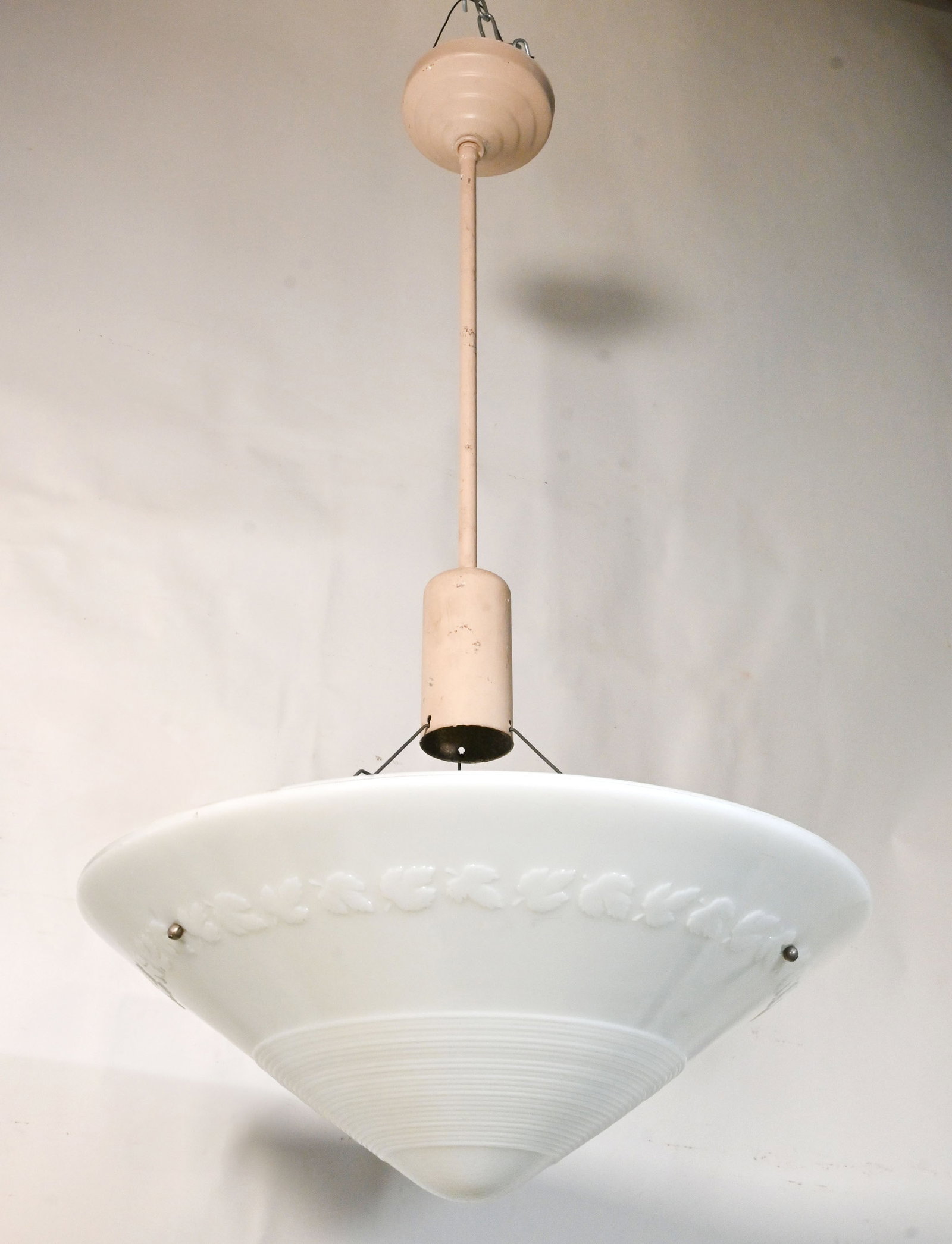 Set of three white molded glass maple leaf shades on 1920s pendants: Set of three white molded glass maple leaf shades on 1920s pendants. Condition: Age Consistent. Material: Molded Glass, Aluminum, Brass, Steel. Currently painted but when stripped reveals industrial a